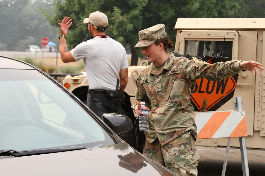 A soldiers helps a local resident with driving directions.