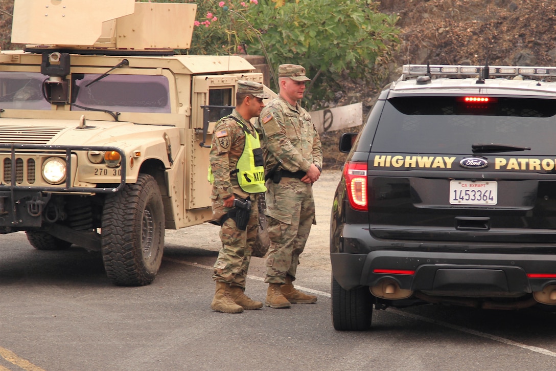 Soldiers update a Shasta County sheriff at the Keswick Dam.