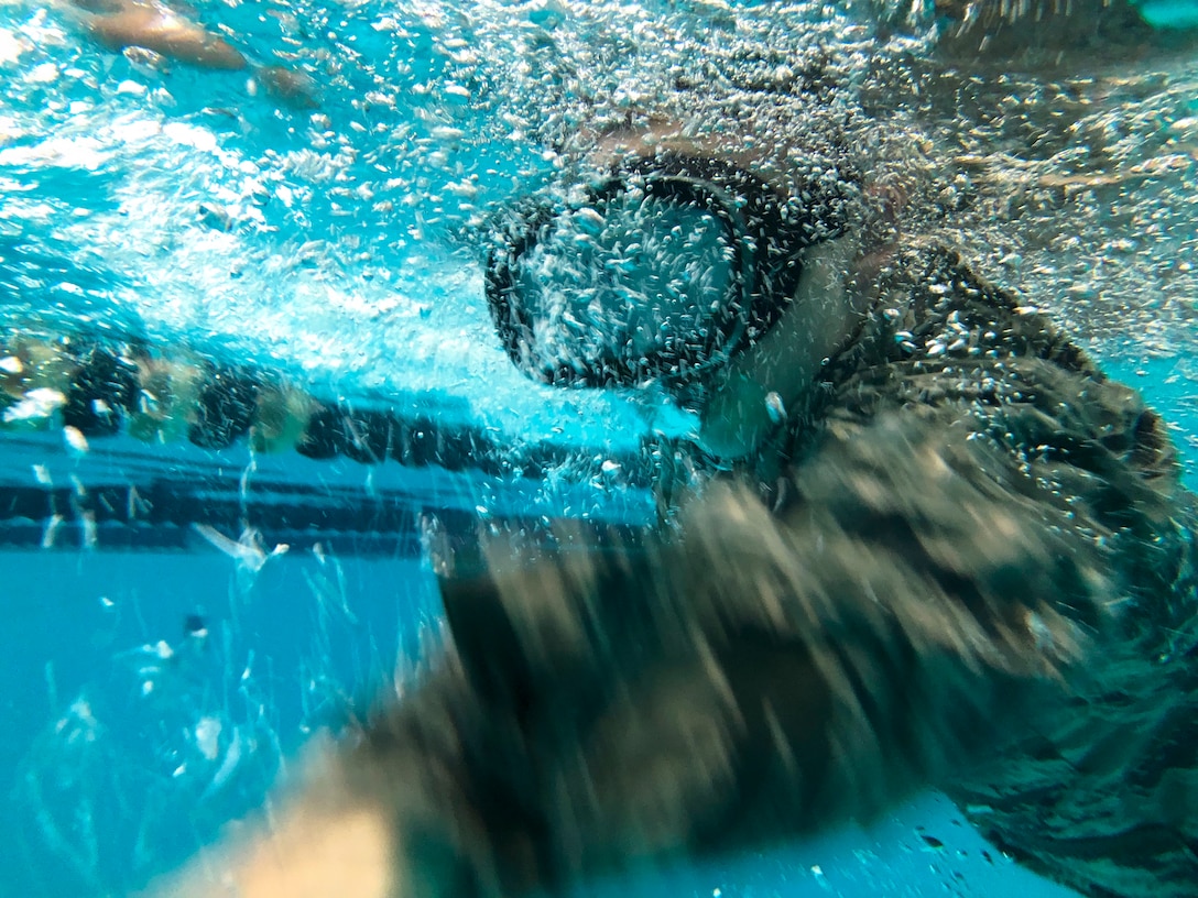 U.S. Air Force Staff Sgt. Austin Goins, 633rd Medical Operations Squadron aerospace medical services technician, swims the length of a pool during water confidence training at Joint Base Langley-Eustis, Va., Aug. 1, 2018.