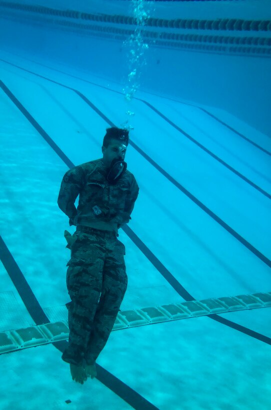 U.S. Air Force Staff Sgt. Michael Svoleantopoulos, 497th Operations Support Squadron tactician, bobs from the base to the surface of a pool during water confidence training at Joint Base Langley-Eustis, Va., Aug. 1, 2018.