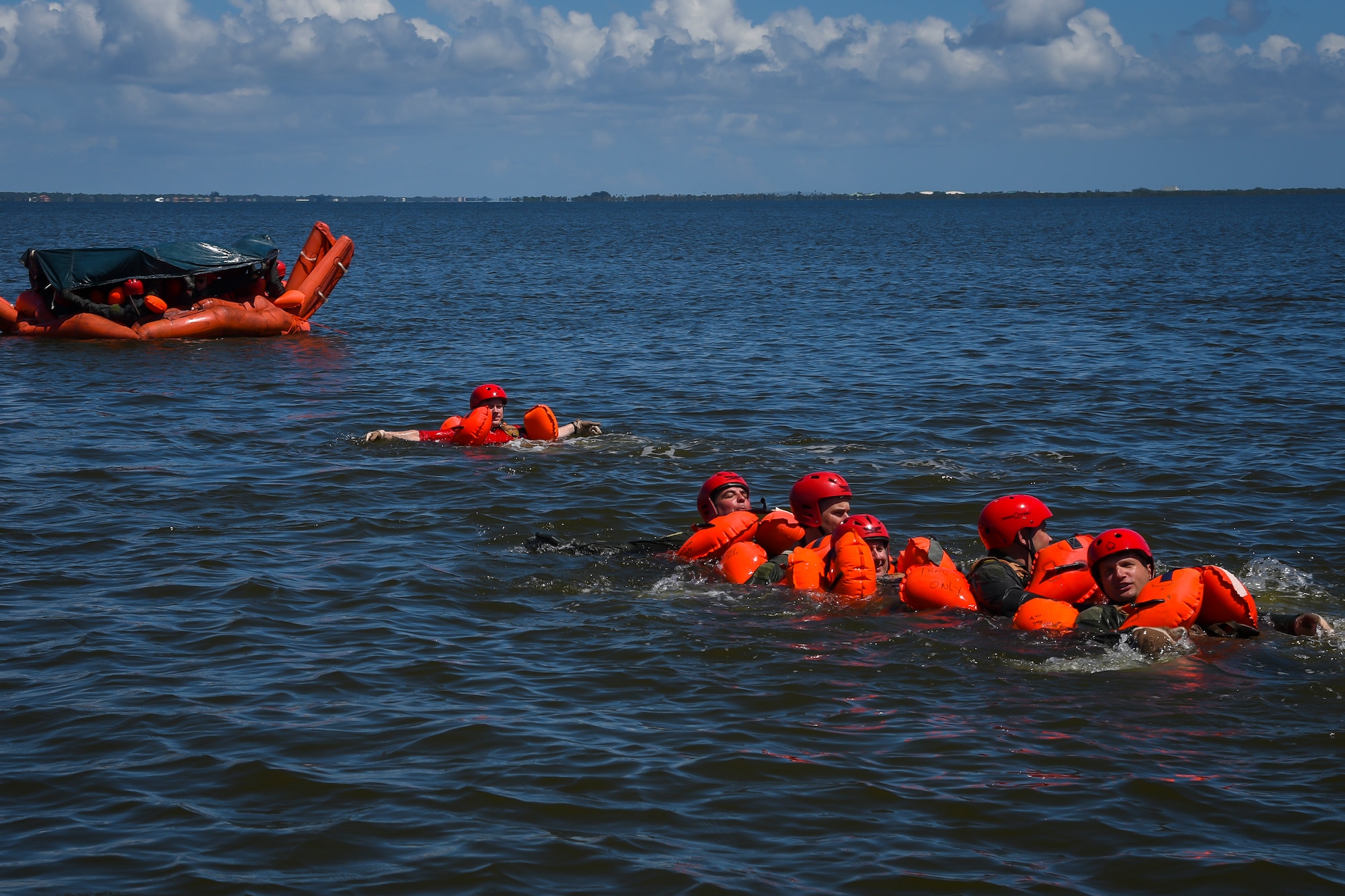 Aircrew from the 39th Rescue Squadron swim towards a life raft Aug. 4, 2018, during water survival training at Patrick Air Force Base, Florida.
