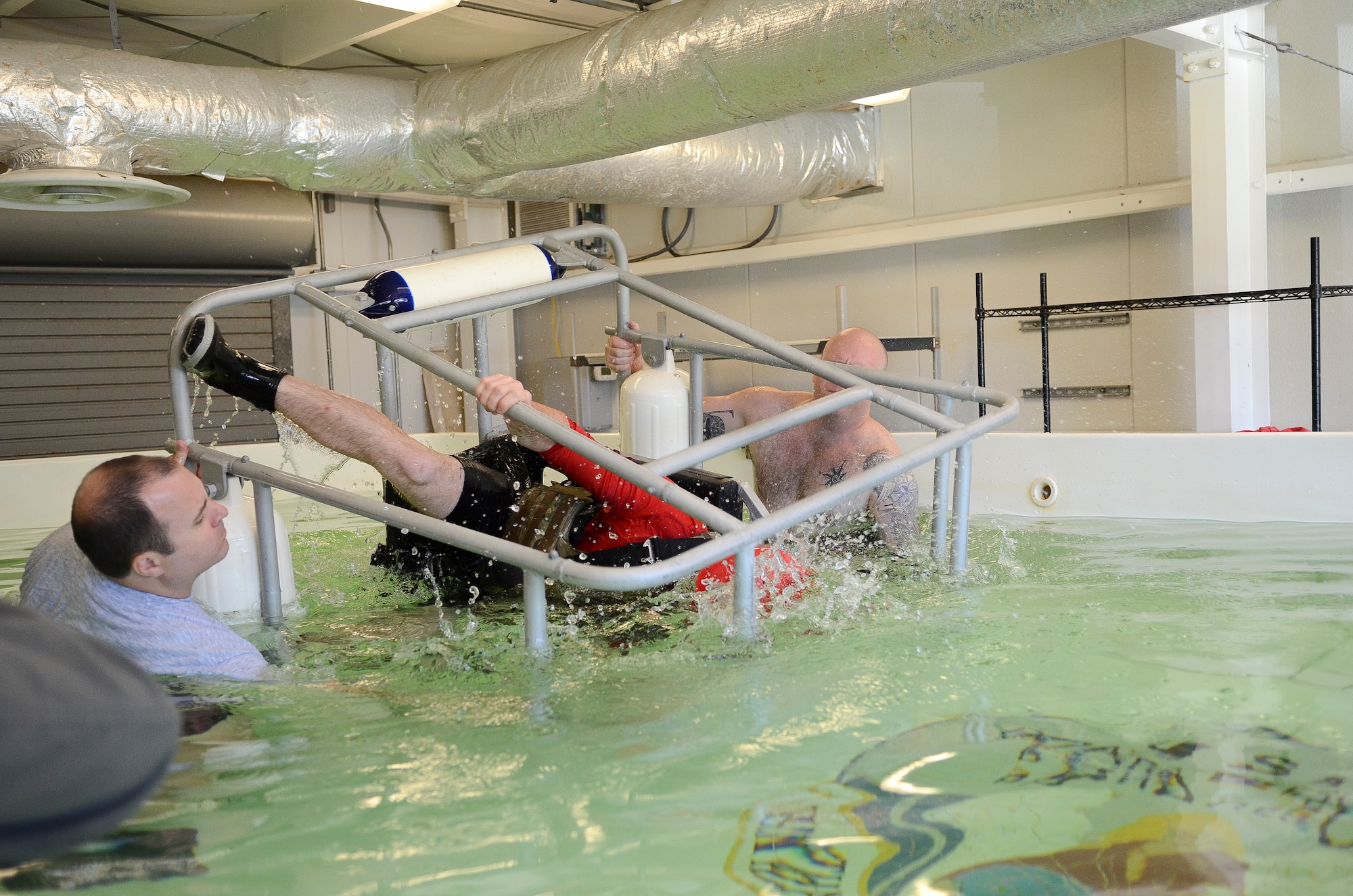 Staff Sgt. Cody Thacker, 308th Rescue Squadron survival, evasion, resistance and escape specialist, demonstrates shallow water egress training Aug. 4, 2018 at Patrick Air Force Base, Florida.