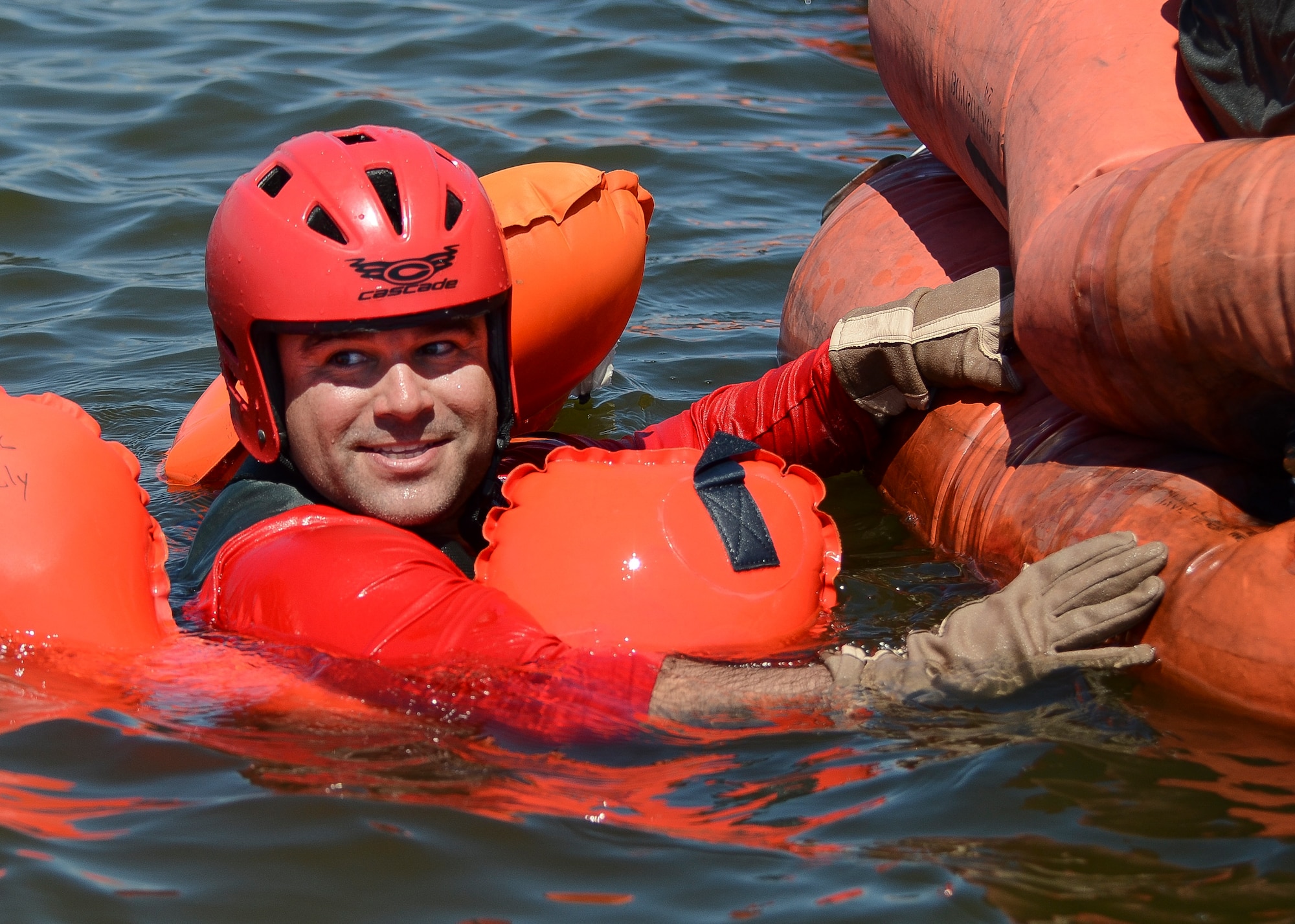 Technical Sgt. Jarrod Burgess, a 920th Operations Support Squadron Aircrew Flight Equipment, Life Support technician, demonstrates boarding a life raft Aug. 4, 2018 at Patrick Air Force Base, Florida.