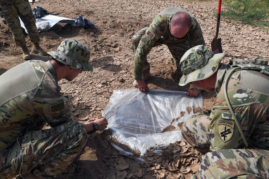 An Air Force airman demonstrates ways to find water during a survival course.