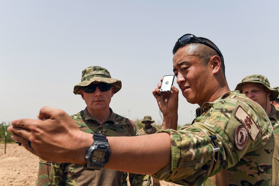 Troops learn how to use a signaling device during training.