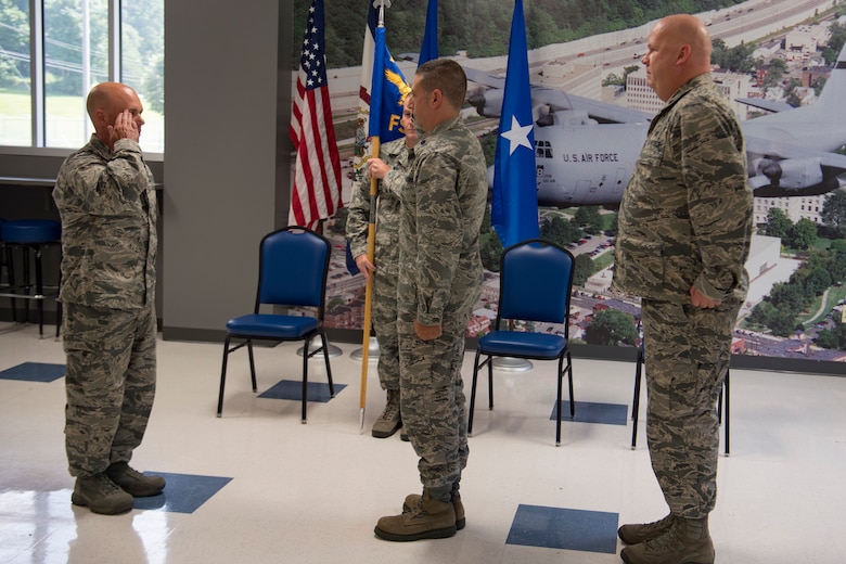Lt. Col. Christian Capece (middle) commits to taking command of the 130th Force Support Squadron from Lt. Col. Rick Thomas, 130th Mission Support Group Commander (left), as Lt. Col. David Lester (right) relinquishes command Aug. 5, 2018 at McLaughlin Air National Guard Base, Charleston, W.Va. Capece was formerly the 130th Airlift Wing's Staff Judge Advocate, which he served as for the last 10 years. (U.S. Air National Guard Photo by Capt. Holli Nelson)