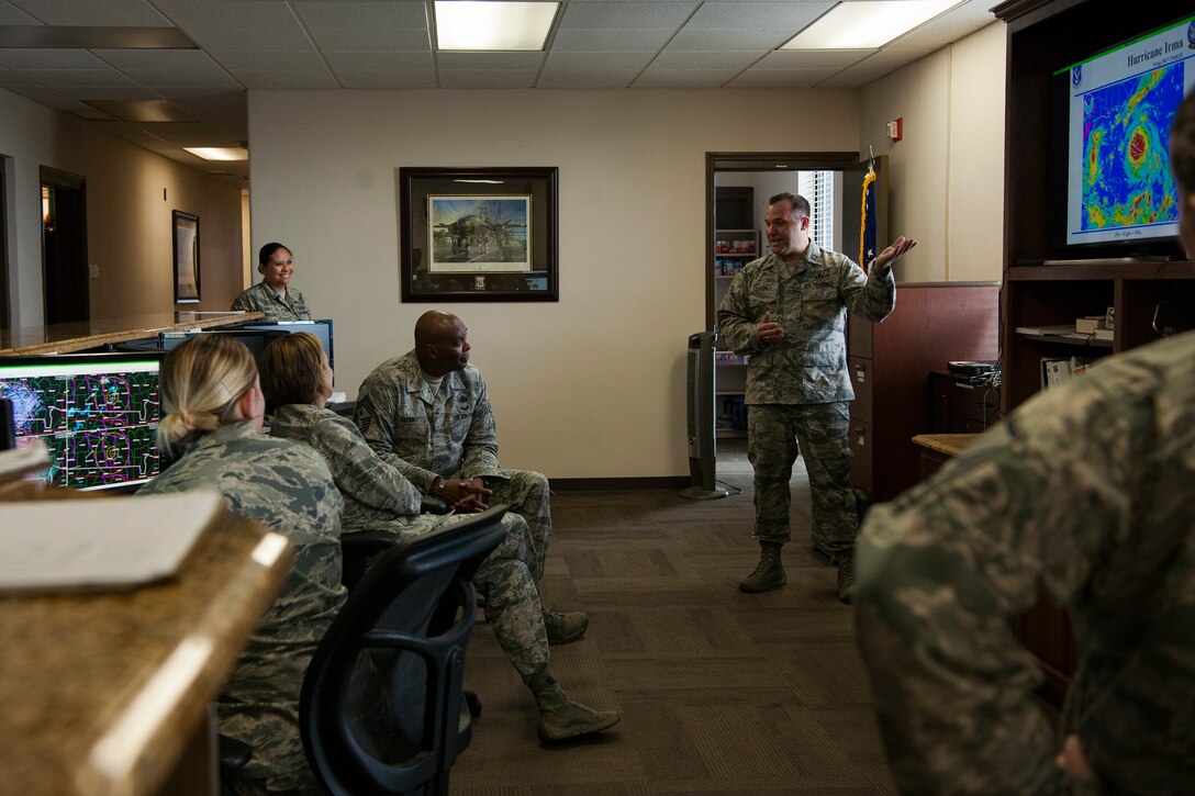 Capt. Michael Ragsdale, right, 23d Operations Support Squadron (OSS) flight commander of weather operations, briefs Col. Jennifer Short, 23d Wing (WG) commander, and Chief Master Sgt. James Allen, 23d WG command chief, during an immersion, Aug. 6, 2018 at Moody Air Force Base, Ga. Wing leadership toured the 23d OSS to meet with Airmen and learn about the day-to-day operations and emergency weather procedures. Throughout their visit, Airmen shared with leadership their opinions and ideas for the continued success and improvement of the 23d OSS. (U.S. Air Force photo by Airman Taryn Butler)