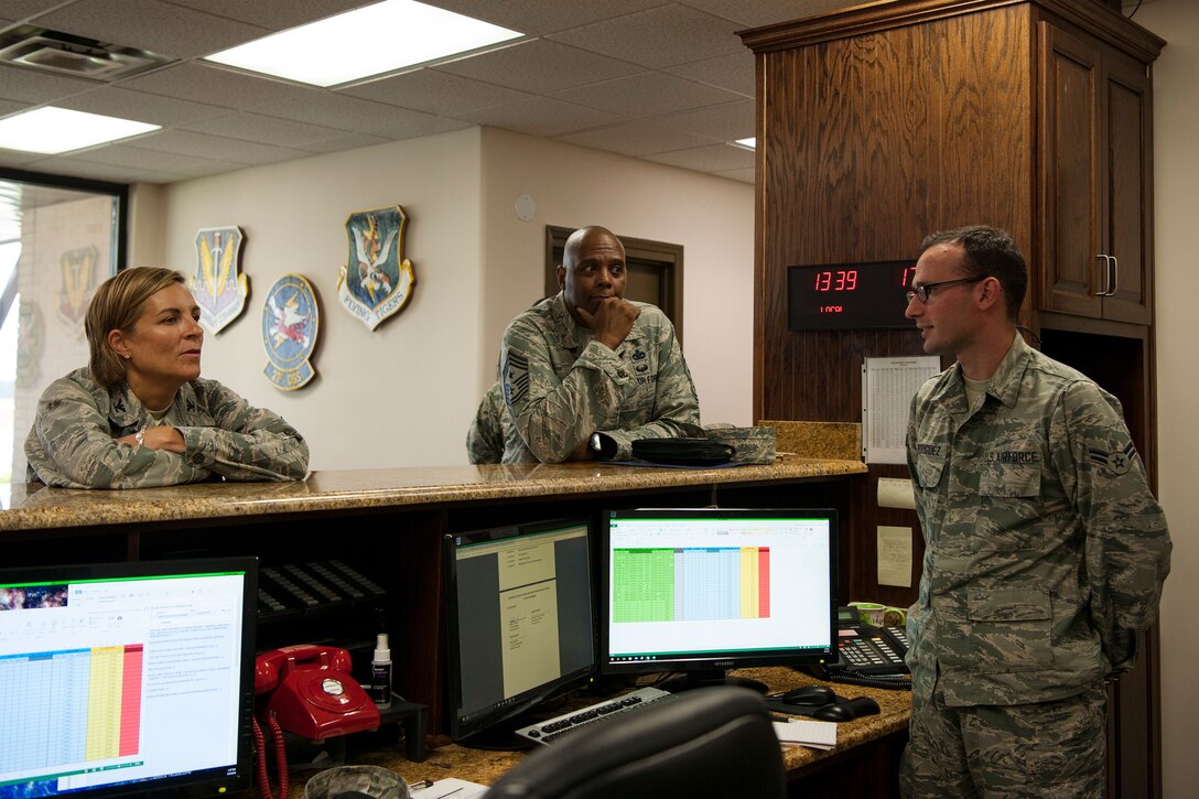 Col. Jennifer Short, left, 23d Wing (WG) commander, and Chief Master Sgt. James Allen, center, 23d WG command chief, talk with Airman 1st Class Alexis Rodriguez, 23d Operations Support Squadron (OSS) airfield manager, during an immersion, Aug. 6, 2018, at Moody Air Force Base, Ga. Wing leadership toured the 23d OSS to meet with Airmen and learn about the day-to-day operations and emergency weather procedures. Throughout their visit, Airmen shared with leadership their opinions and ideas for the continued success and improvement of the 23d OSS. (U.S. Air Force photo by Airman Taryn Butler)