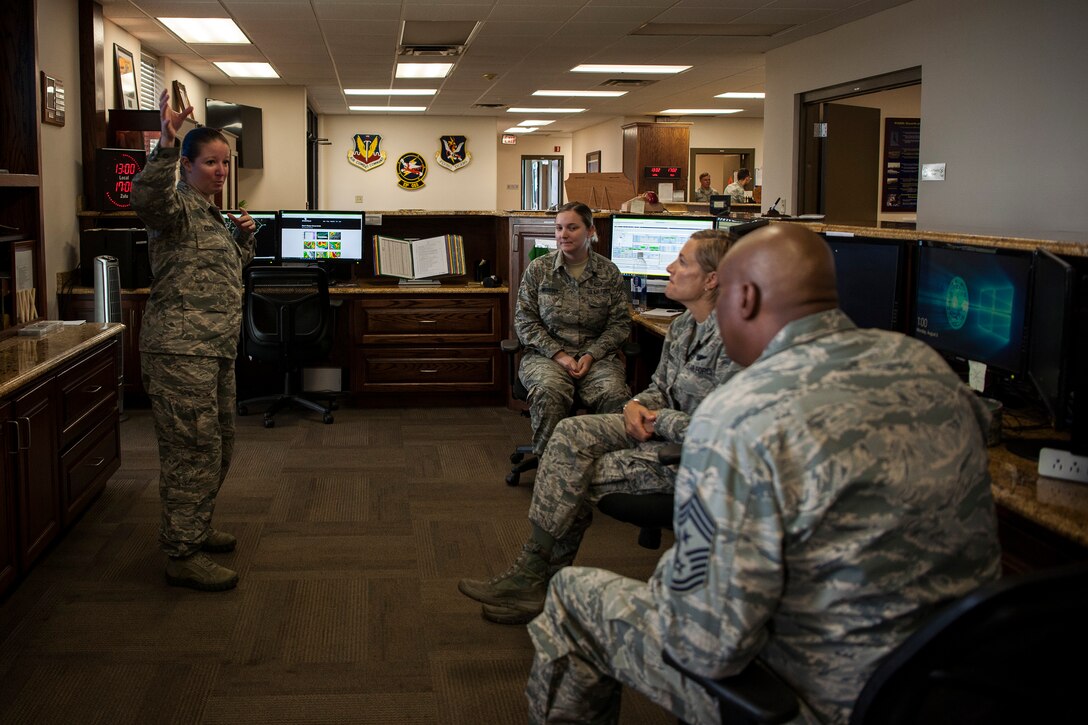 Master Sgt. Nicole Curran, left, 23d Operations Support Squadron (OSS) flight chief of weather operations, briefs Col. Jennifer Short, 23d Wing (WG) commander, and Chief Master Sgt. James Allen, 23d WG command chief, during an immersion, Aug. 6, 2018, at Moody Air Force Base, Ga. Wing leadership toured the 23d OSS to meet with Airmen and learn about the day-to-day operations and emergency weather procedures. Throughout their visit, Airmen shared with leadership their opinions and ideas for the continued success and improvement of the 23d OSS. (U.S. Air Force photo by Airman Taryn Butler)