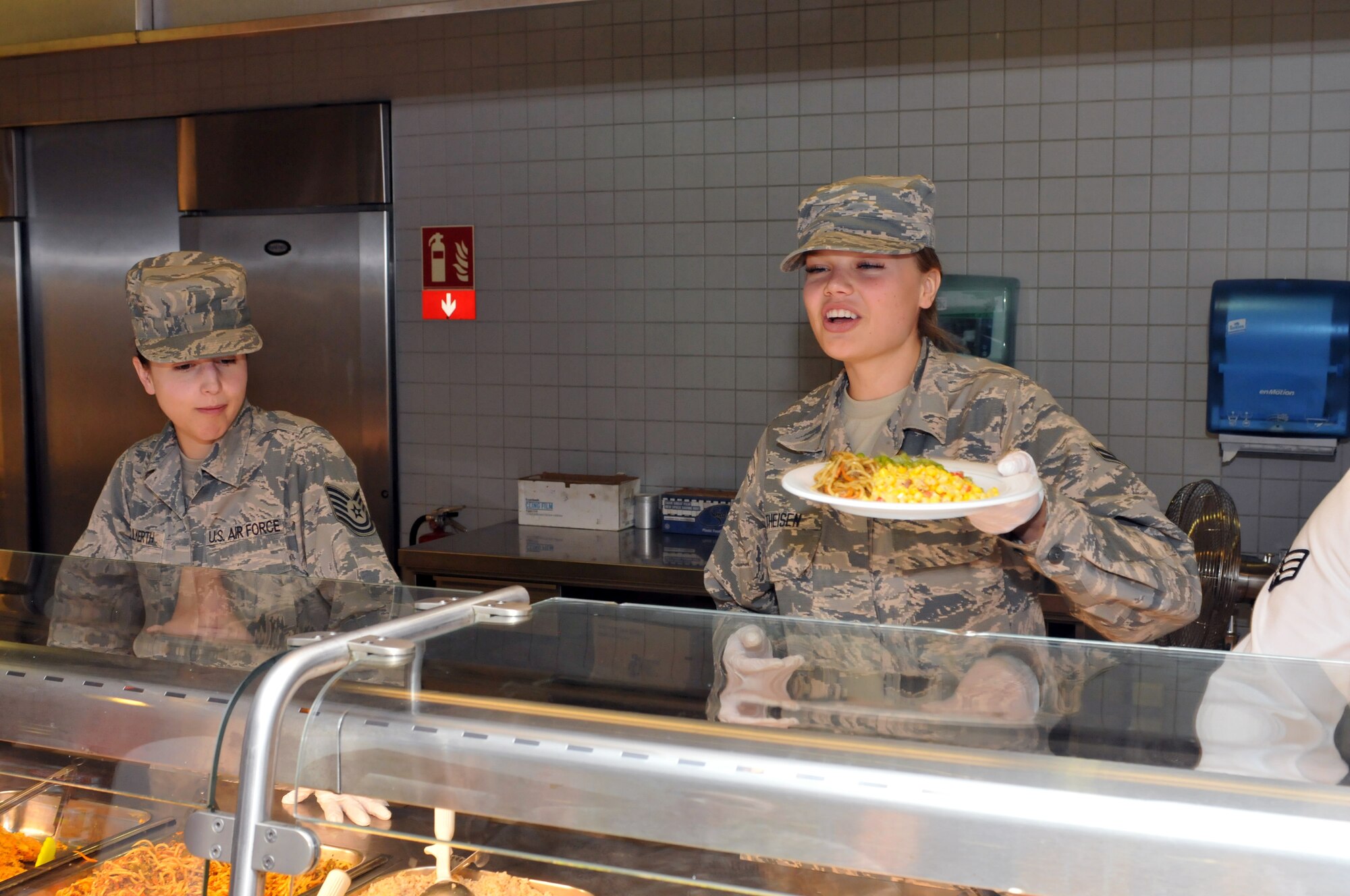Airman 1st Class Mackenzie Theisen with the Iowa Air National Guard’s 185th Air Refueling Wing’s Force Support Squadron serves up some hot chow at Ramstein Air Base, Germany in June, 2018. Several members of the unit were in German for training alongside their active duty counterparts. U.S. Air National Guard photo by Master Sgt. Bill Wiseman.