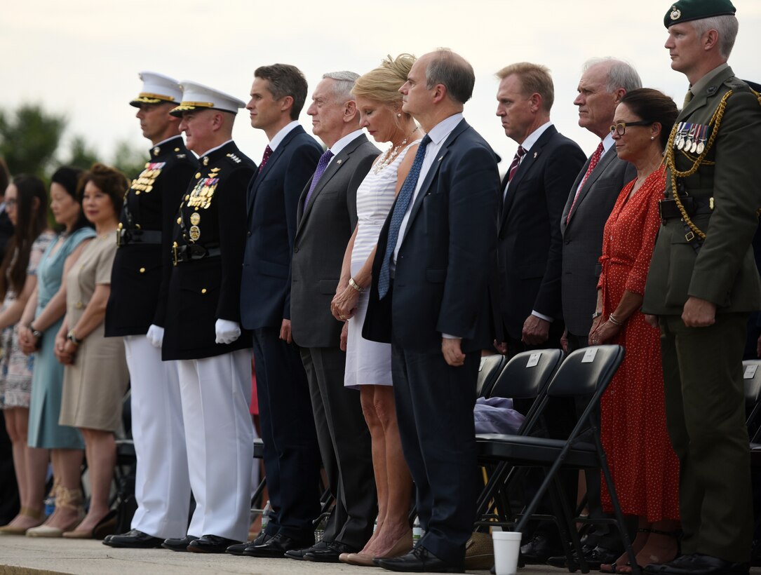 Defense Secretary James N. Mattis and British Defense Secretary Gavin Williamson stand at attention.