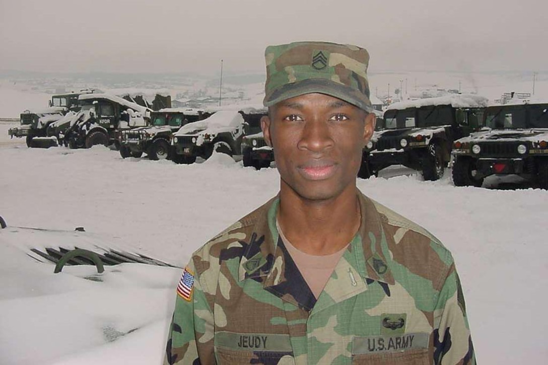 A soldier poses for a photograph in the snow.