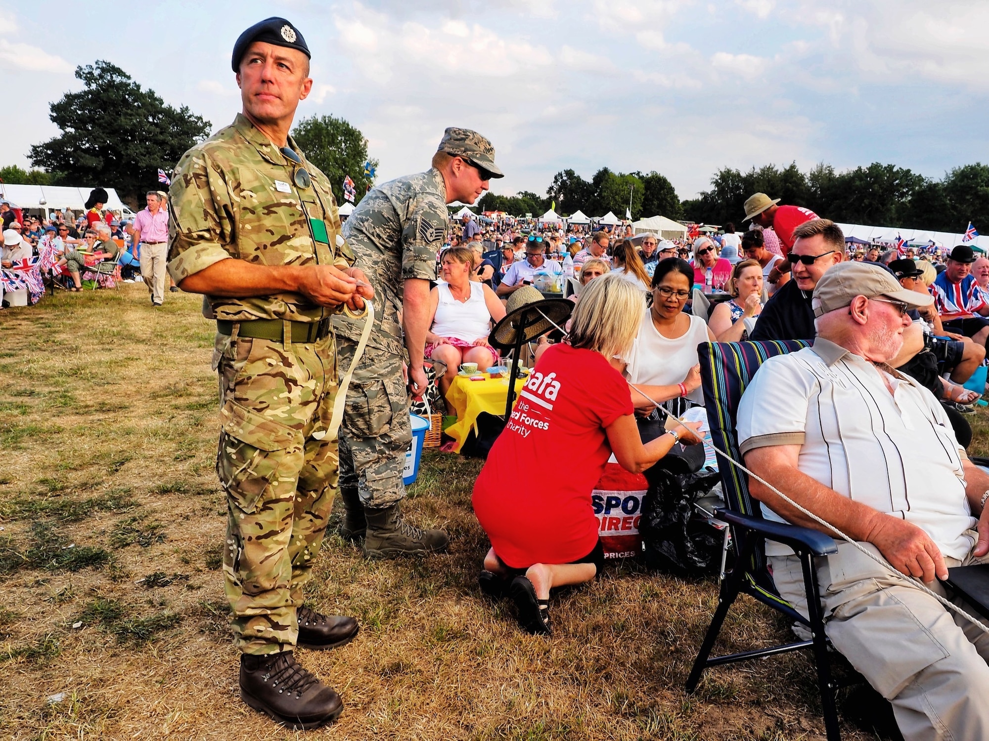 U.S. Air Force Staff Sgt. Jason Chipley (center), 145th Logistics Readiness Squadron, helps with collecting donations for a charity event during Battle Proms at Hatfield Park, Hatfield, United Kingdom, July 14, 2018. The Military Reserve Exchange Program not only allows military members to learn and exchange ideas about their respective career fields, but it also provides the opportunity to be immersed in the host country’s culture.