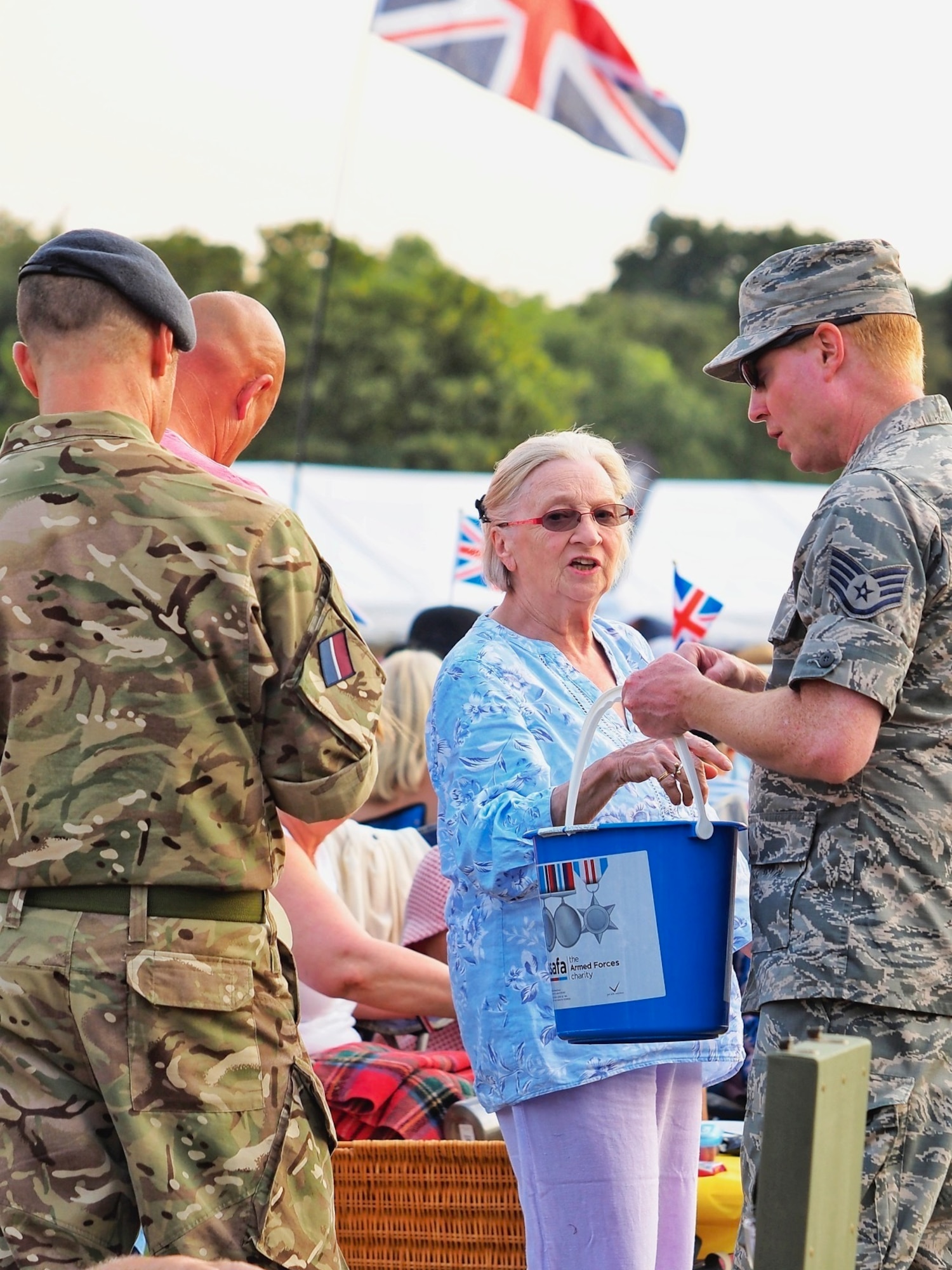 U.S. Air Force Staff Sgt. Jason Chipley (center), 145th Logistics Readiness Squadron, helps with collecting donations for a charity event during Battle Proms at Hatfield Park, Hatfield, United Kingdom, July 14, 2018. The Military Reserve Exchange Program not only allows military members to learn and exchange ideas about their respective career fields, but it also provides the opportunity to be immersed in the host country’s culture.