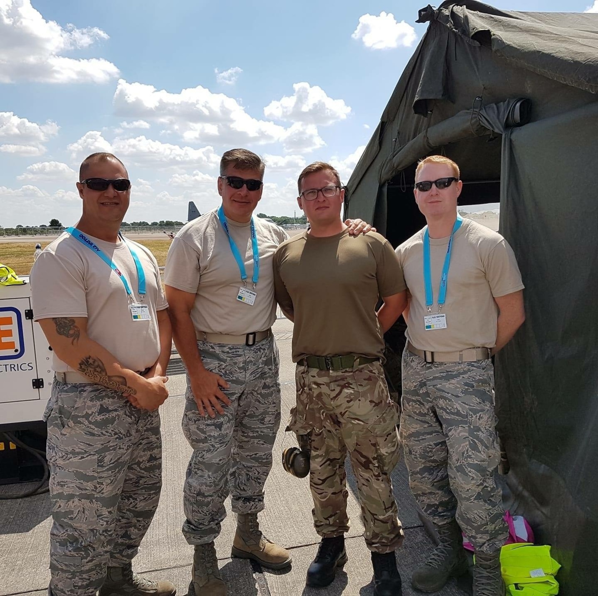 U.S. Air Force Staff Sgt. Jason Chipley (right), 145th Logistics Readiness Squadron, poses with members from the United States Air Force Reserves and Royal Air Force during the Air Tattoo air show at RAF Fairford, Fairford, United Kingdom, July 14, 2018. The Military Reserve Exchange Program not only allows military members to learn and exchange ideas about their respective career fields, but it also provides the opportunity to be immersed in the host country’s culture.