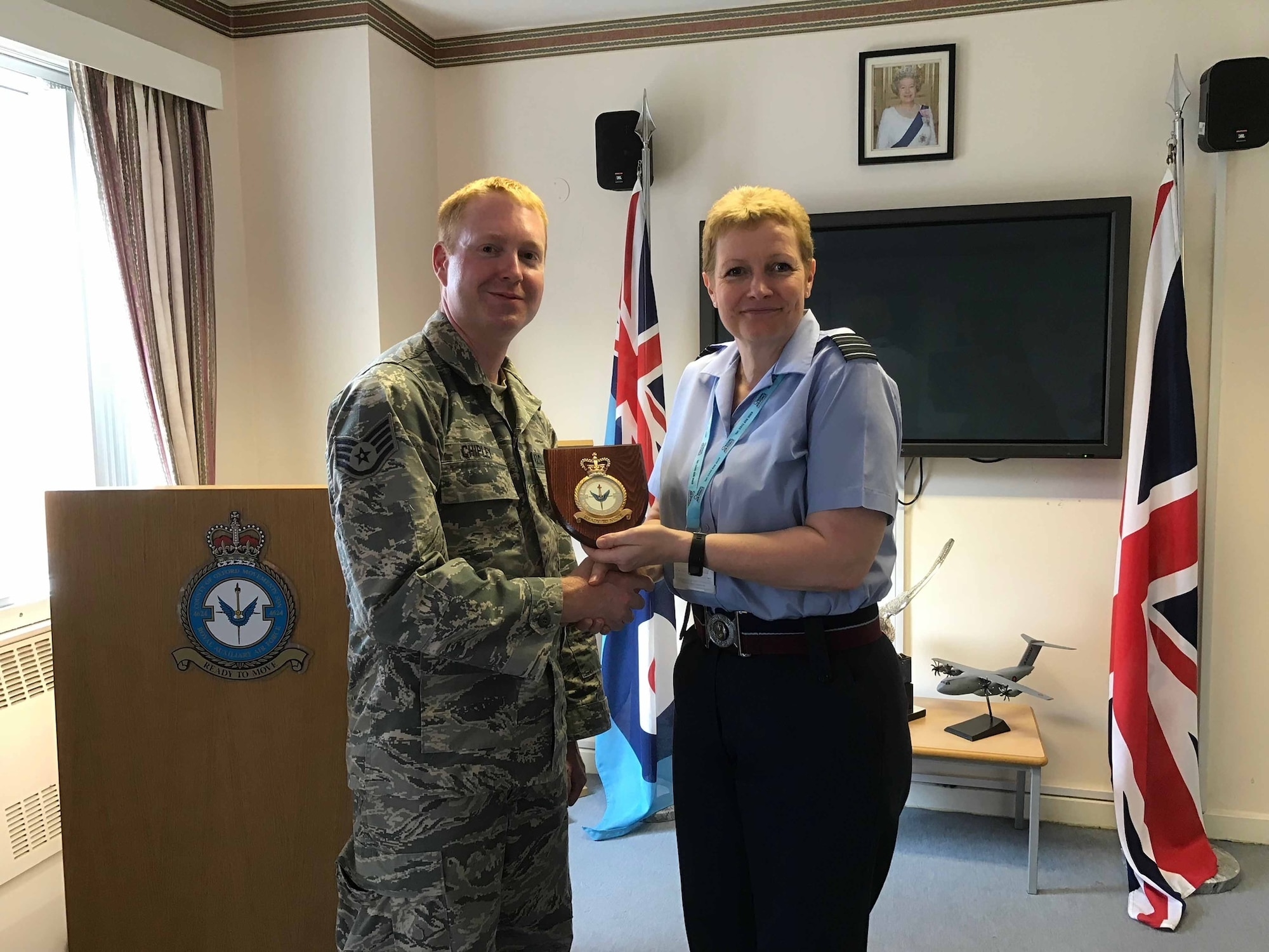 U.S. Air Force Staff Sgt. Jason Chipley, 145th Logistics Readiness Squadron, receives a squadron plaque from the commanding officer of the 4624 Squadron Royal Air Force Reserves, Oxfordshire, United Kingdom, July 19, 2018. The Military Reserve Exchange Program provides National Guard and Reserve Participants training associated with mobilization duties while enhancing their ability to work and communicate with military individuals of the host nation.