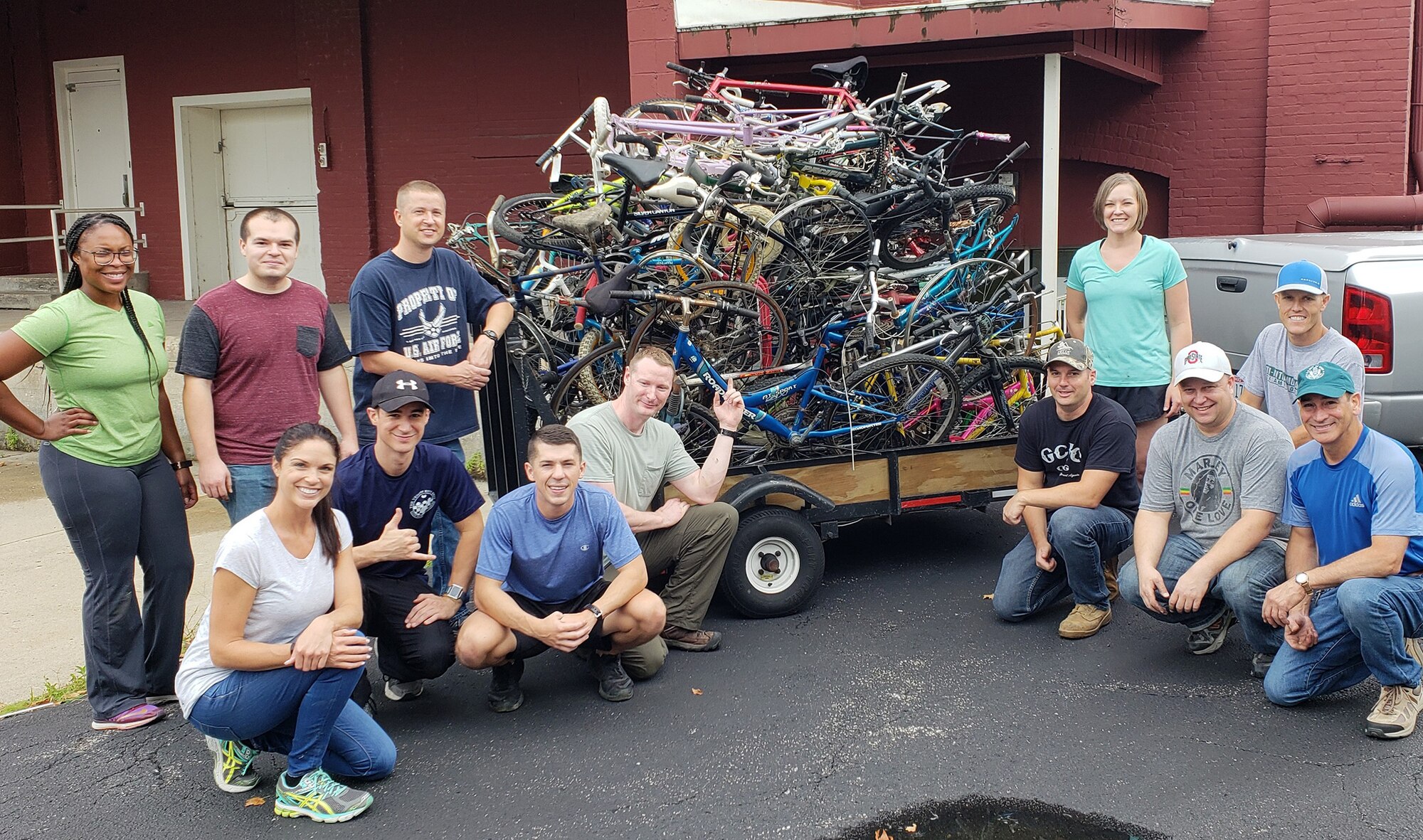 Members of the 655th Intelligence, Surveillance and Reconnaissance Group’s, 14th Intelligence Squadron, proudly pose after loading 1,400 pounds of scrap bicycle materials at Bicycles for All, Dayton, Ohio, July 20, 2018.
