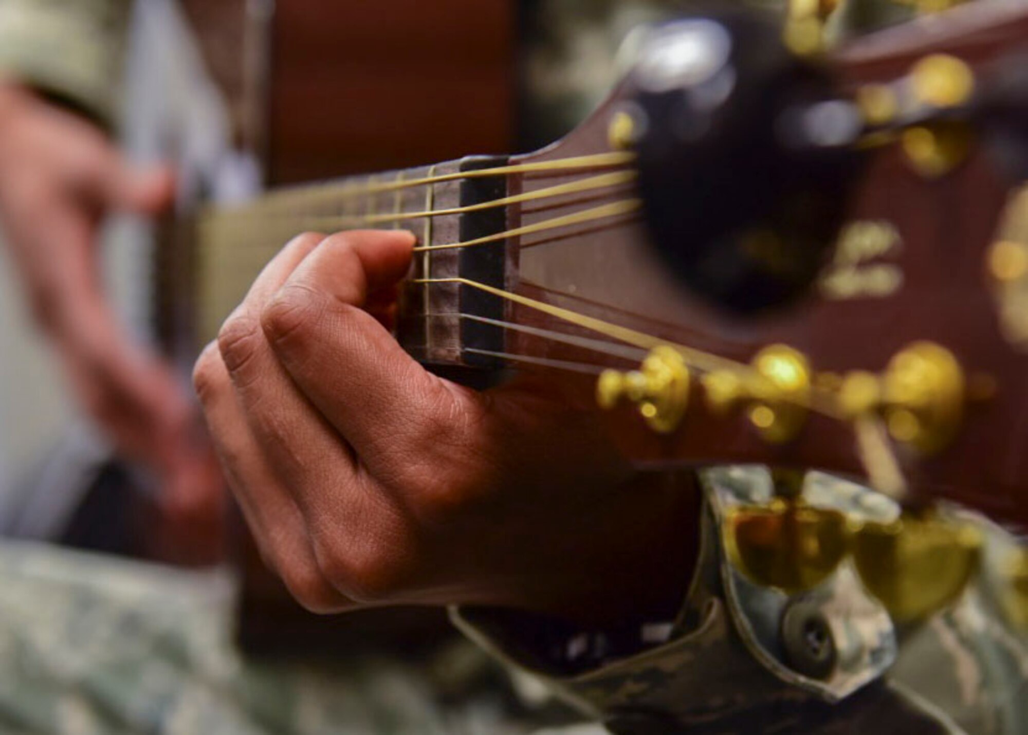 U.S. Air Force Staff Sgt. Michael Burks, 1st Maintenance Squadron precision measurement equipment lab technician, plays guitar at Joint Base Langley-Eustis, Virginia, July 31, 2018.