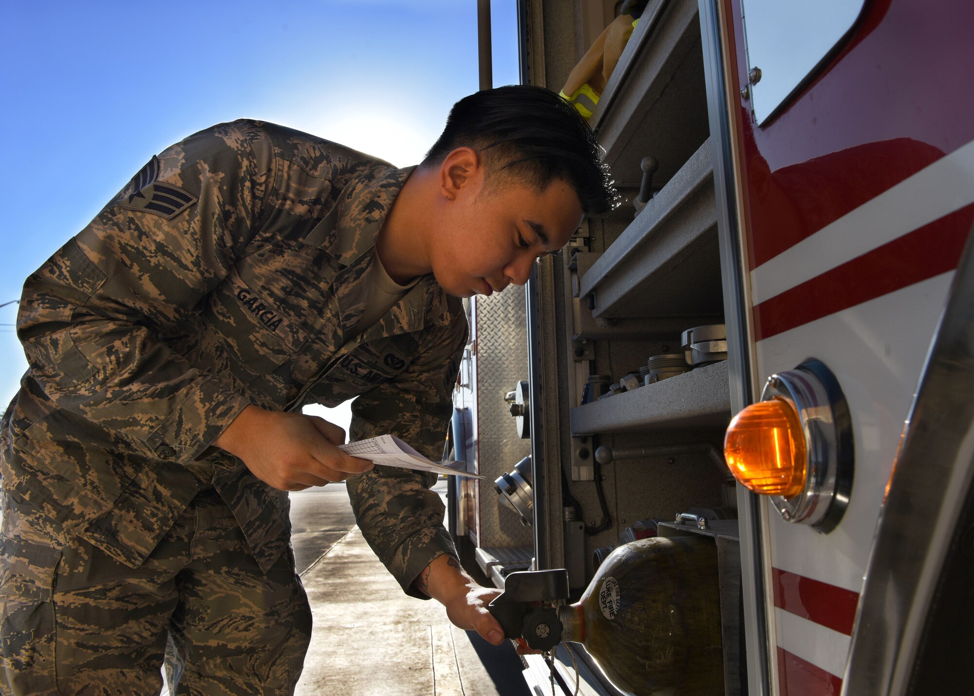 Senior Airman Jammie Garcia, 56th Civil Engineer Squadron firefighter, looks over equipment on a fire engine Aug. 6, 2018, at Luke Air Force Base, Ariz.