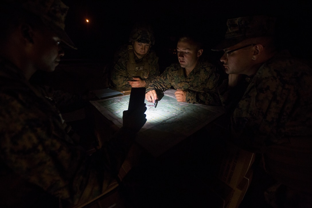 Motor transportation Marines with 3rd Battalion, 25th Marine Regiment, go over delivery routes before dropping off chow to units in the field during Exercise Northern Strike at Camp Grayling, Mich., Aug. 7, 2018.
