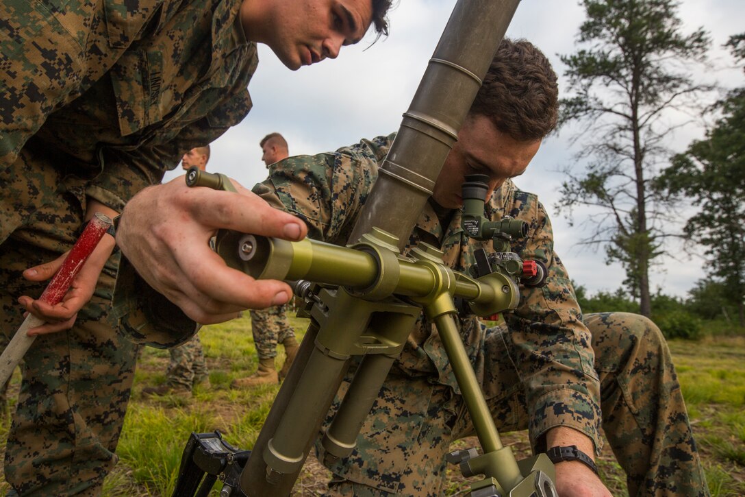 Lance Cpl. Alexander Banik, a mortarman with Lima Company, 3rd Battalion, 25th Marine Regiment, adjust a M224 60mm Mortar during Exercise Northern Strike at Camp Grayling, Mich., Aug. 7, 2018.