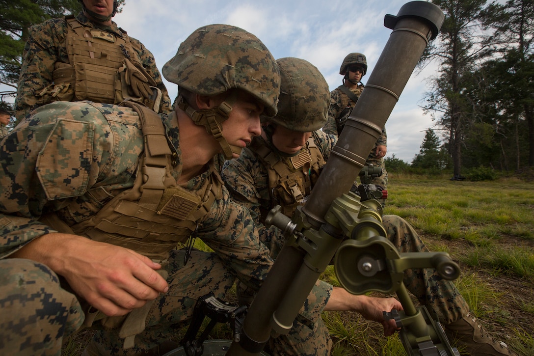 Lance Cpl. Vince Walls (left) and Lance Cpl. Alexander Banik (right), mortarmen with Lima Company, 3rd Battalion, 25th Marine Regiment, adjust a M224 60mm Mortar during Exercise Northern Strike at Camp Grayling, Mich., Aug. 7, 2018.
