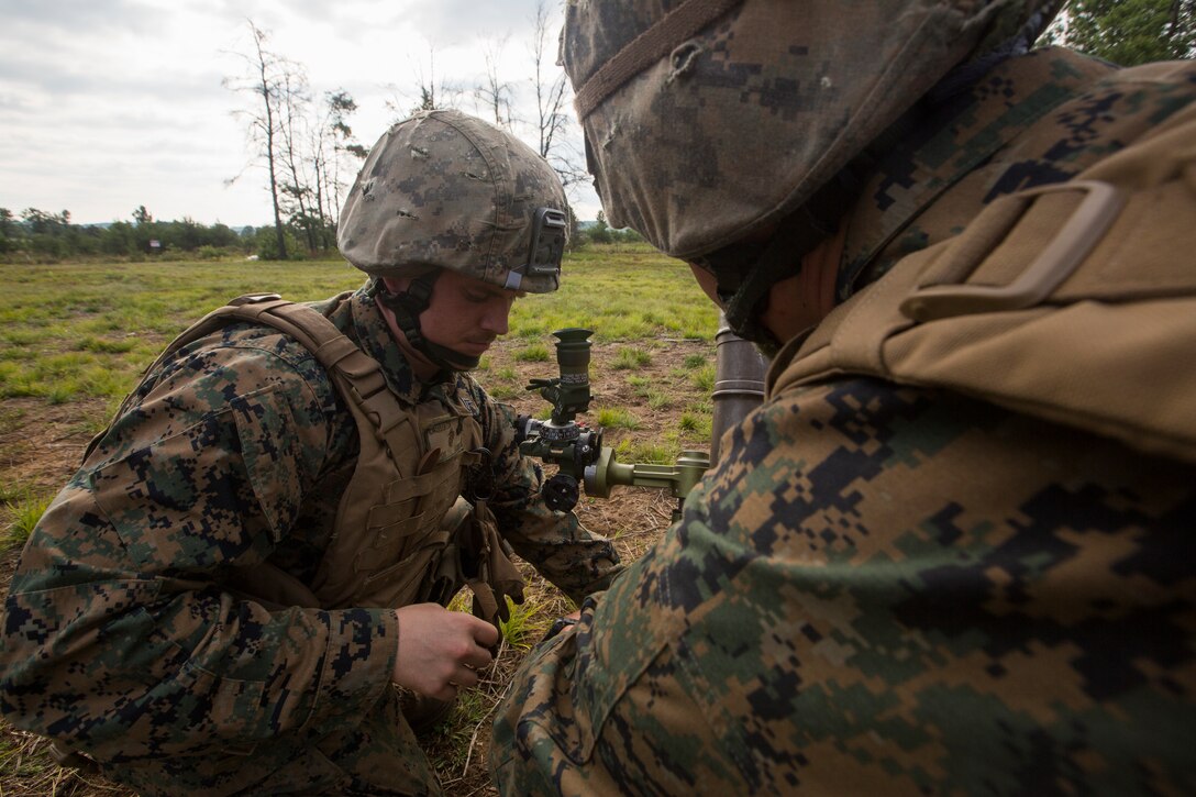 Cpl. Eric Cruser, a mortarman with Lima Company, 3rd Battalion, 25th Marine Regiment, adjusts a M224 60mm Mortar during Exercise Northern Strike at Camp Grayling, Mich., Aug. 7, 2018.