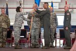 Brig. Gen. Paige Hunter, Assistant Adjutant General for Air, passes the 167th Airlift Wing guidon to Col. David "DC" Cochran during a formal change of command ceremony held Aug. 5, 2018, in Martinsburg, West Virginia. Cochran assumed command of the wing from outgoing commander Col. Shaun Perkowski. (U.S. Air National Guard photo by Senior Master Sgt. Emily Beightol-Deyerle)