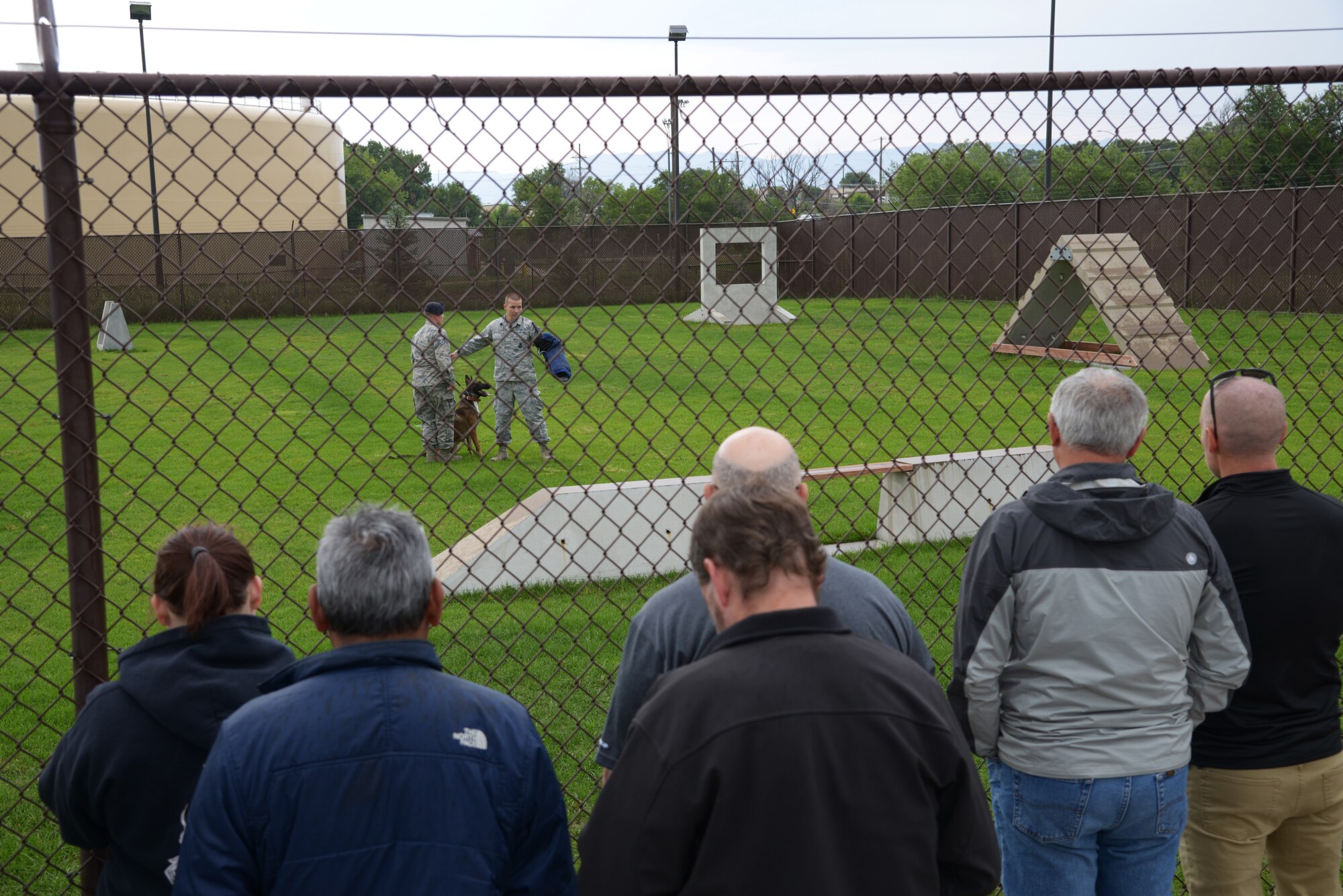 Civilian employers watch a military working dog demonstration led by the 21st Security Forces Squadron Aug. 3, 2018, at Peterson Air Force Base, Colorado. Civilian employers of 302nd Airlift Wing reservists were invited to attend Employer Appreciation Day to get a snapshot of the wing’s mission and background on the Air Force Reserve program. (U.S. Air Force photo by Staff Sgt. Justin R. Norton)