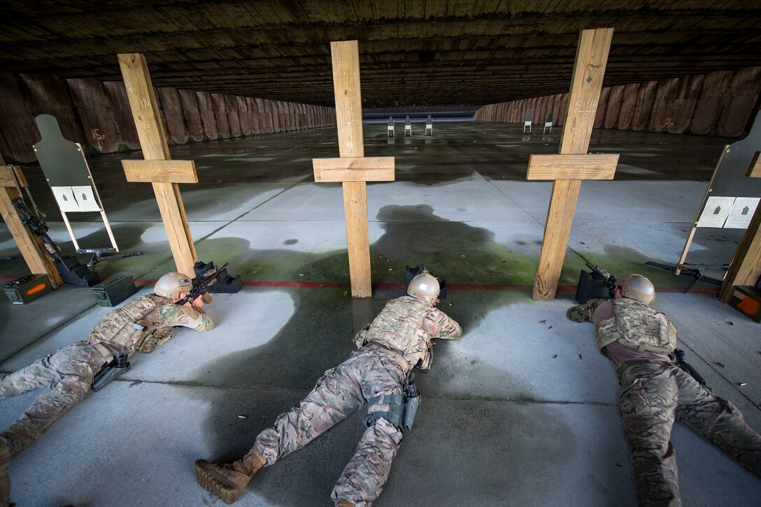 Airmen from the 820th Base Defense Group and 23d Security Forces Squadron fire M4 carbines during the shooting competition portion of the Defender Challenge assessment, July 30, 2018, at Moody Air Force Base, Ga. Seven Moody defenders trudged through a gauntlet that tested their capability, lethality and readiness. Ultimately, only Senior Airman Jeffrey Lewis, 822d Base Defense Squadron fireteam leader, had the scores, determination and perseverance to advance to the next level for a chance to represent Air Combat Command during the 2018 Defender Challenge, Sept. 8-14, at Joint Base San Antonio-Camp Bullis, Texas. (U.S. Air Force photo by Airman 1st Class Erick Requadt)