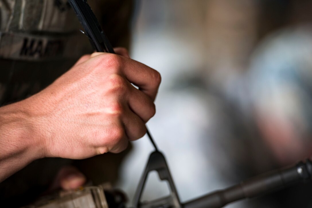 Senior Airman Ethan Martin, 23d Security Forces Squadron reports and analysis clerk, adjusts his shooting sight while participating in the shooting competition portion of the Defender Challenge assessment, July 30, 2018, at Moody Air Force Base, Ga. Seven Moody defenders trudged through a gauntlet that tested their capability, lethality and readiness. Ultimately, only Senior Airman Jeffrey Lewis, 822d Base Defense Squadron fireteam leader, had the scores, determination and perseverance to advance to the next level for a chance to represent Air Combat Command during the 2018 Defender Challenge, Sept. 8-14, at Joint Base San Antonio-Camp Bullis, Texas. (U.S. Air Force photo by Airman 1st Class Erick Requadt)