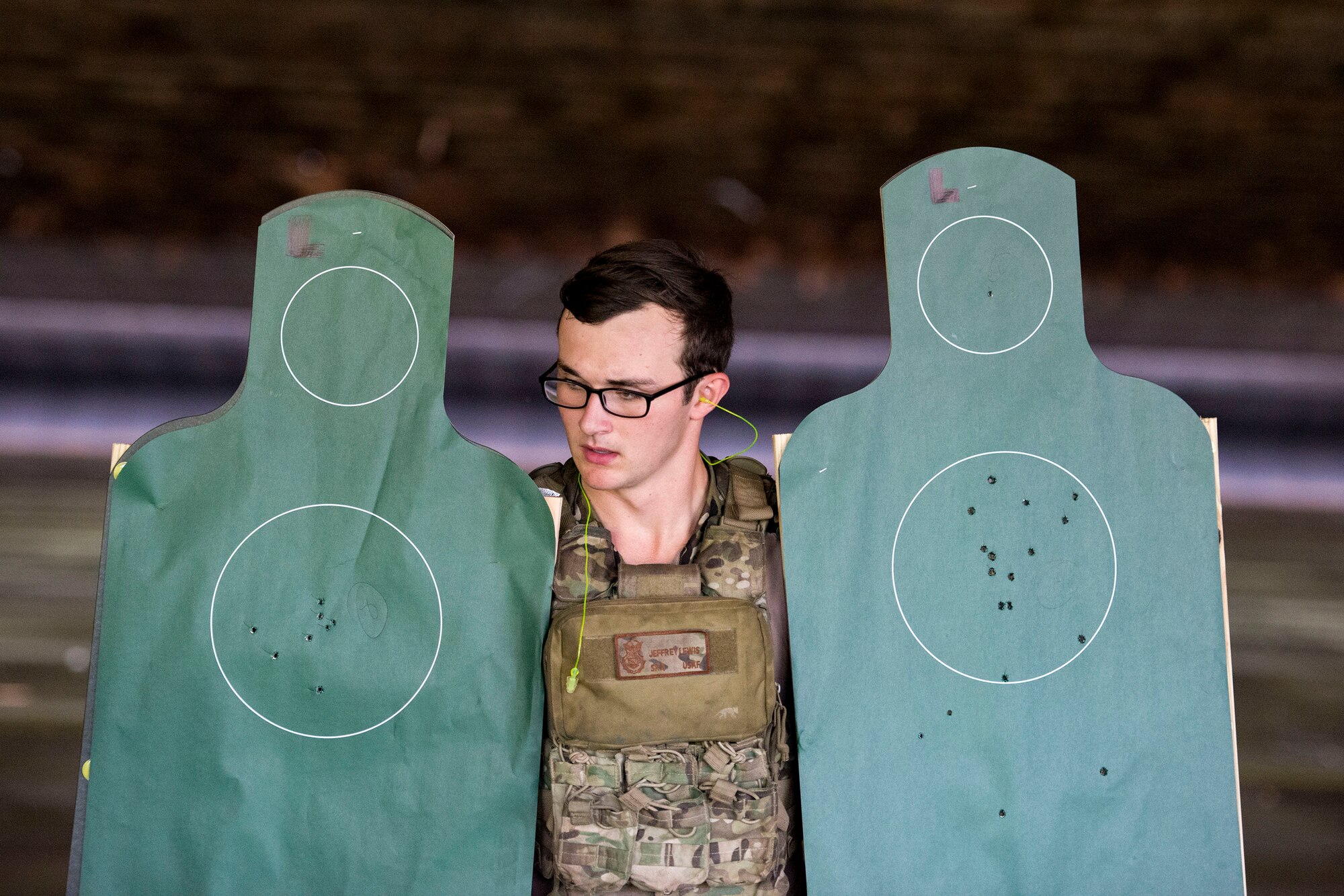 Senior Airman Jeffrey Lewis, 822d Base Defense Squadron fireteam leader, carries targets back after the shooting competition portion of the Defender Challenger assessment, July 30, 2018, at Moody Air Force Base, Ga.  Seven Moody defenders trudged through a gauntlet that tested their capability, lethality and readiness. Ultimately, only Lewis had the scores, determination and perseverance to advance to the next level for a chance to represent Air Combat Command during the 2018 Defender Challenge, Sept. 8-14, at Joint Base San Antonio-Camp Bullis, Texas. (U.S. Air Force photo by Airman 1st Class Erick Requadt)