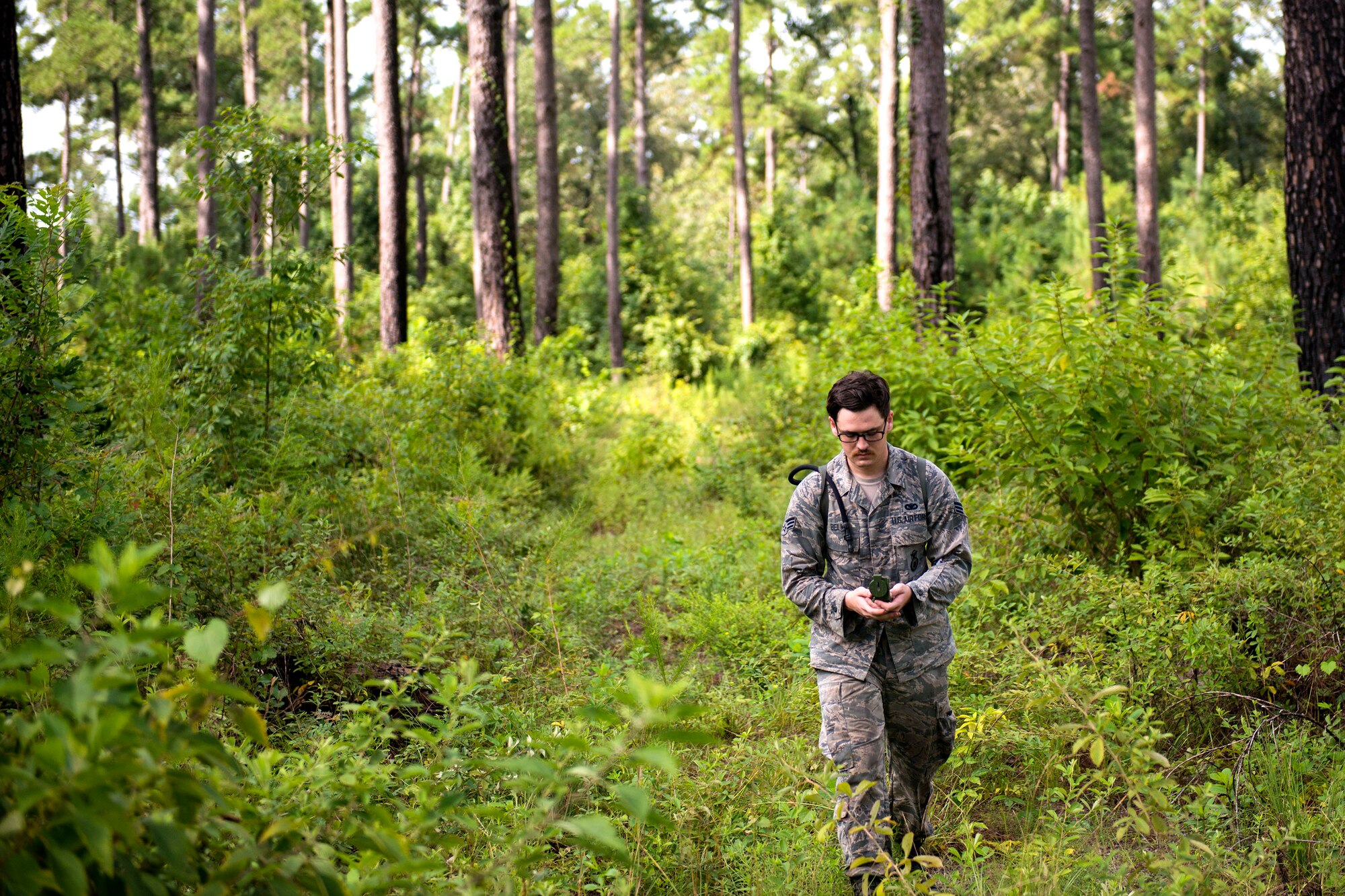 Senior Airman Parker Bell, 23d Security Forces Squadron section patrolman, examines a compass during the land-navigation portion of the Defender Challenge assessment, July 30, 2018, at Moody Air Force Base, Ga. Seven Moody defenders trudged through a gauntlet that tested their capability, lethality and readiness. Ultimately, only Senior Airman Jeffrey Lewis, 822d Base Defense Squadron fireteam leader, had the scores, determination and perseverance to advance to the next level for a chance to represent Air Combat Command (ACC) during the 2018 Defender Challenge, Sept. 8-14, at Joint Base San Antonio-Camp Bullis, Texas. (U.S. Air Force photo by Airman 1st Class Erick Requadt)