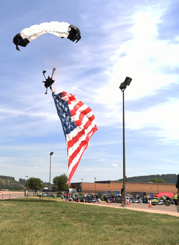 Retired Army 1st Sgt., Dana Bowman, a former Golden Knight parachute team member, skydives to the ground at Sturgis, S.D., Aug. 7, 2018. Bowman is a disabled veteran who lost both his legs while serving his country. He continues to skydive as a way to honor veterans and those who continue to serve. (U.S. Air Force photo by Airman 1st Class Thomas Karol)