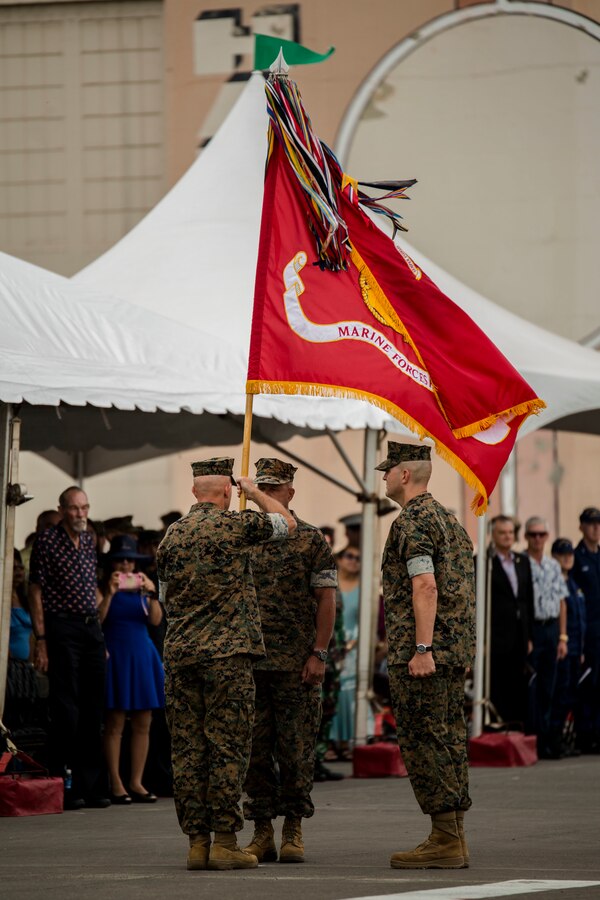 U.S. Marine Corps Lt. Gen. David H. Berger, right, outgoing commander, U.S. Marine Corps Forces, Pacific, passes the MARFORPAC colors to U.S. Marine Lt. Gen. Lewis A. Craparotta, the incoming commander, during the MARFORPAC change of command ceremony at Marine Corps Base Hawaii, Aug. 8, 2018. The change of command ceremony represents the transfer or responsibility and authority between commanders.