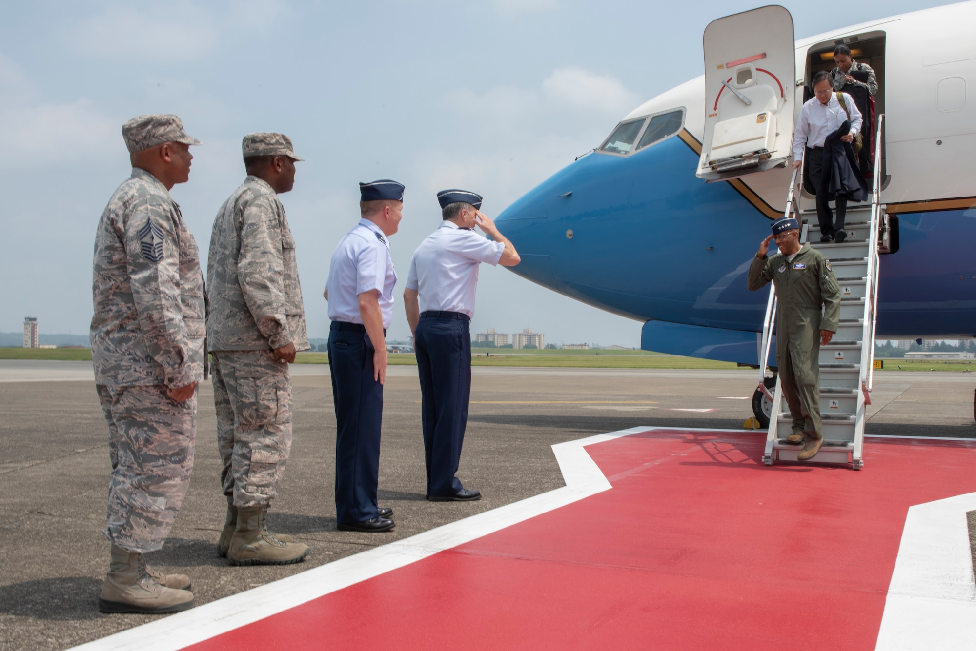 Lt. Gen. Jerry P. Martinez, U.S. Forces Japan and Fifth Air Force commander, salutes Gen. CQ Brown, Jr., Pacific Air Forces commander, upon his arrival to Yokota Air Base, Japan, Aug. 6, 2018.