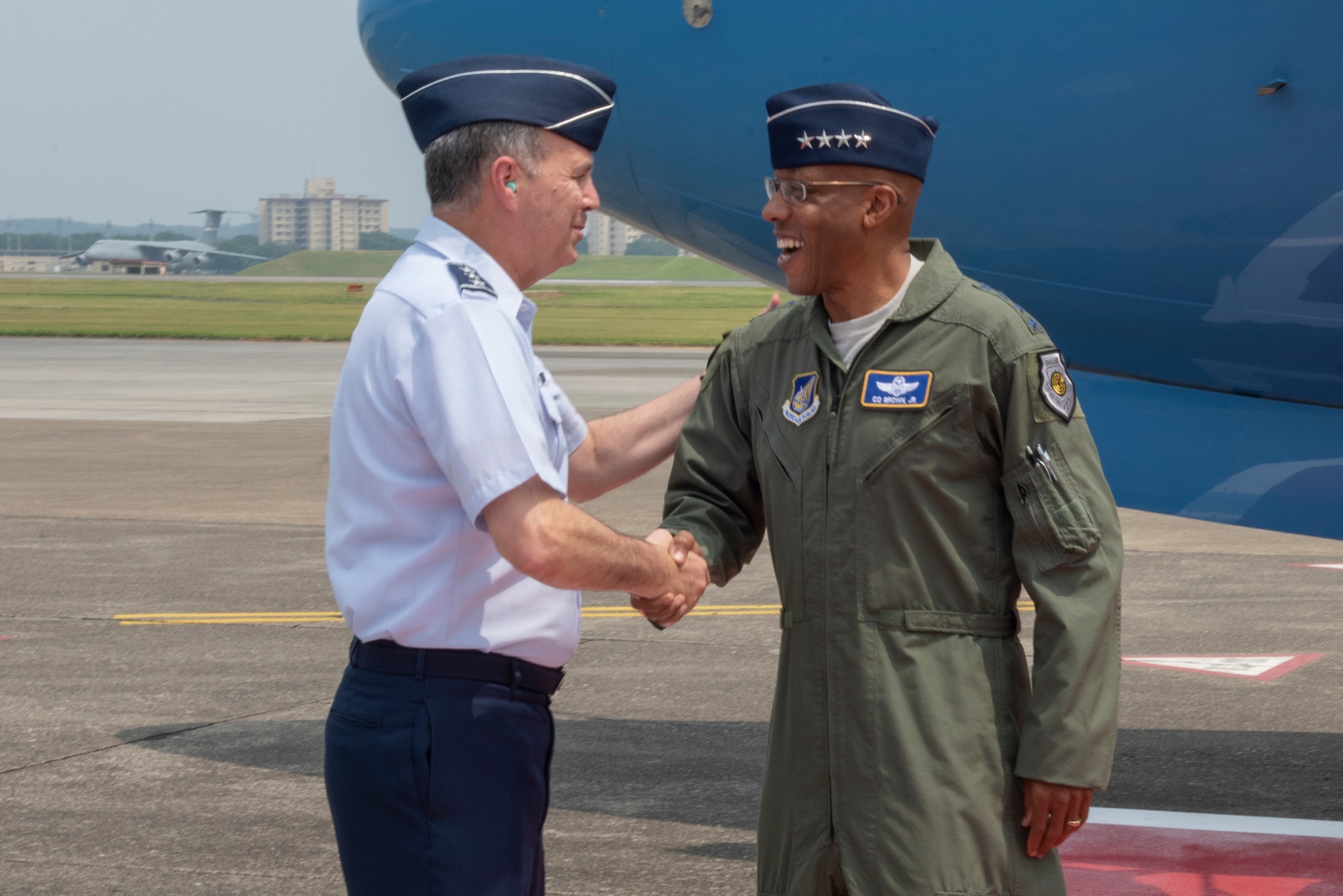 Lt. Gen. Jerry P. Martinez, U.S. Forces Japan and Fifth Air Force commander, shakes hands with Gen. CQ Brown, Jr., Pacific Air Forces commander, upon his arrival to Yokota Air Base, Japan, Aug. 6, 2018.