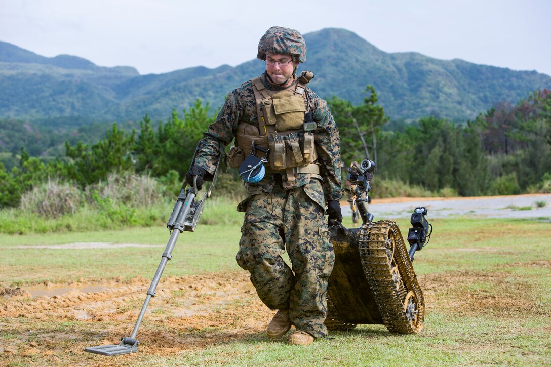Staff Sgt. David Cain retrieves a Mark II Talon Explosive Ordnance Disposal robot during charge employment training Aug. 2, 2018 at Camp Hansen, Okinawa, Japan. The training taught EOD technicians to effectively neutralize improvised explosive devices with unmanned robotic platforms by safely finding and removing any hazards. Cain, a native of Fredericksburg, Virginia, is an EOD technician with EOD Company, 9th Engineer Support Battalion, 3rd Marine Logistics Group. (U.S. Marine Corps photo by Lance Cpl. Isabella Ortega)