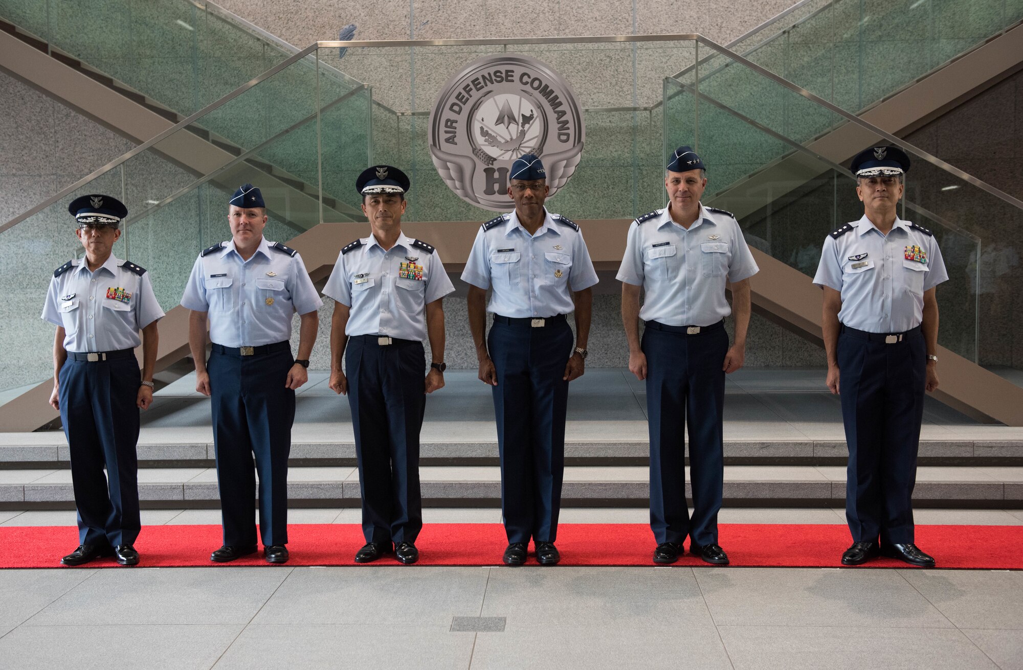 U.S. Air Force from left to right: Brig. Gen. Todd Dozier, Fifth Air Force vice commander, Gen. CQ Brown, Jr.,Pacific Air Forces commander, and Lt. Gen. Jerry Martinez, U.S. Forces Japan and Fifth Air Force commander, pose for a group photo with Lt. Gen. Shigeki Muto (center, left), Japanese Air Defense Command (ADC) commander and members of his staff at ADC headquarters at Yokota Air Base, Japan, Aug. 6, 2018. Brown visited the country to affirm the United States' shared commitment to a free and open Indo-Pacific as well as to seek opportunities to enhance cooperation and coordination across the alliance. (U.S. Air Force photo by Staff Sgt. Hailey Haux)