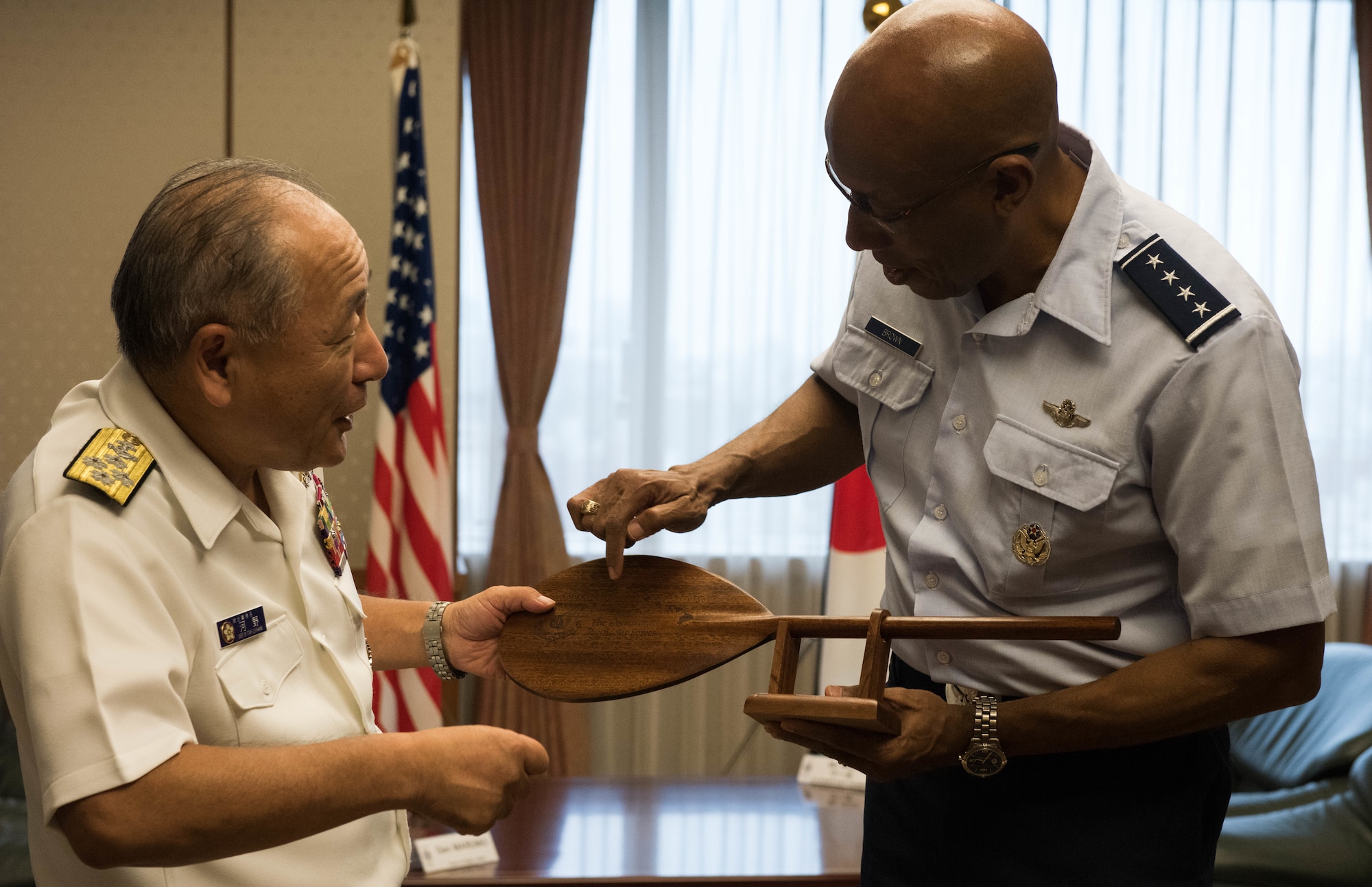 Gen. CQ Brown, Jr., Pacific Air Forces commander, presents a gift to ADM Katsutoshi Kawano, Japanese Chief of Joint Staff, after an office call with him at the Ministry of Defense in Tokyo, Japan, Aug. 7, 2018. Brown visited the country to affirm the United States' shared commitment to a free and open Indo-Pacific as well as to seek opportunities to enhance cooperation and coordination across the alliance. For more than 60 years, the U.S.-Japan alliance has been the cornerstone for stability and security in the region. (U.S. Air Force photo by Hailey Haux)