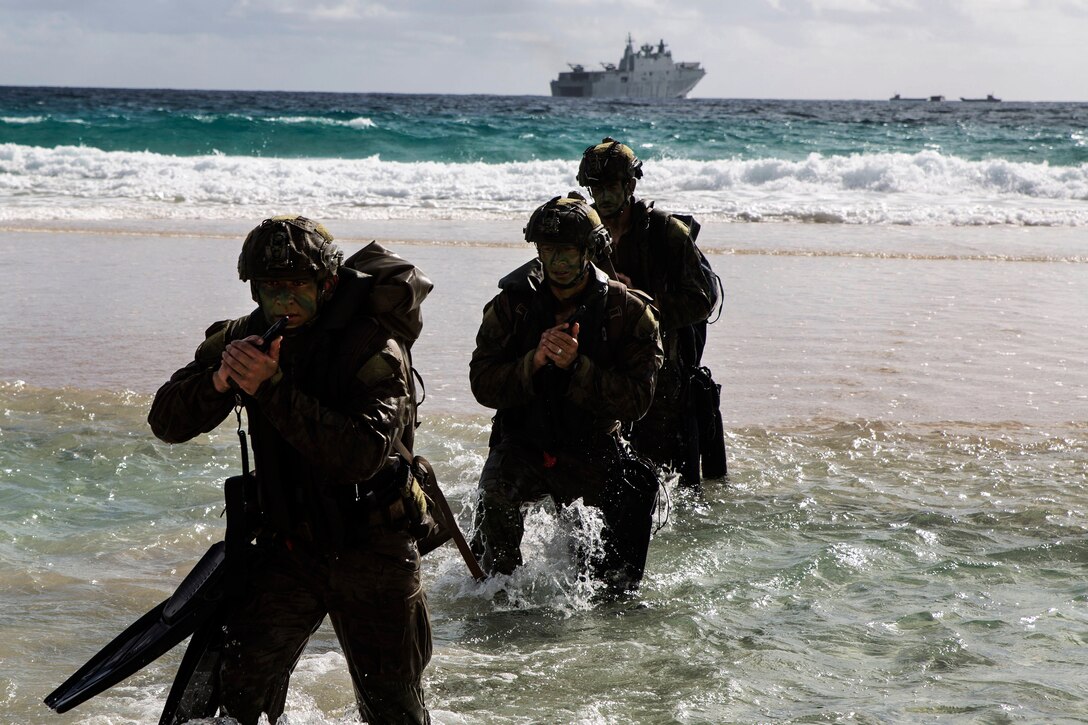 Australian troops conduct an amphibious assault landing.