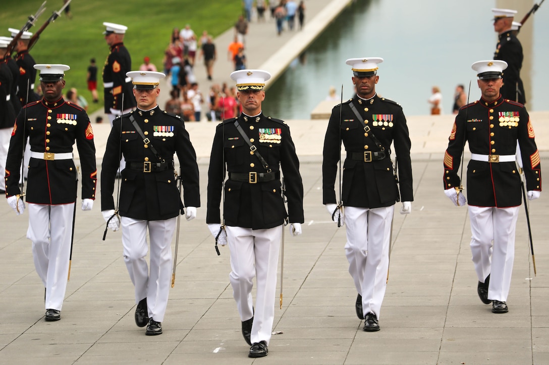 Marines with the Marine Barracks Washington D.C. parade marching staff march across the parade deck during a Tuesday Sunset Parade at the Lincoln Memorial, Washington D.C., Aug. 7, 2018. The guest of honor for the parade was the Right Honourable Gavin Williamson, MP Secretary of State for Defence of the United Kingdom and the hosting official was Gen. Glenn M. Walters, assistant commandant of the Marine Corps.