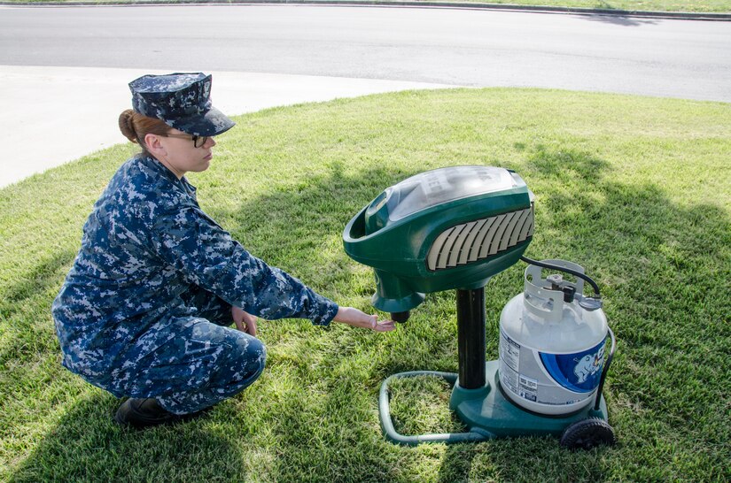 A sailor operates a mosquito trap.