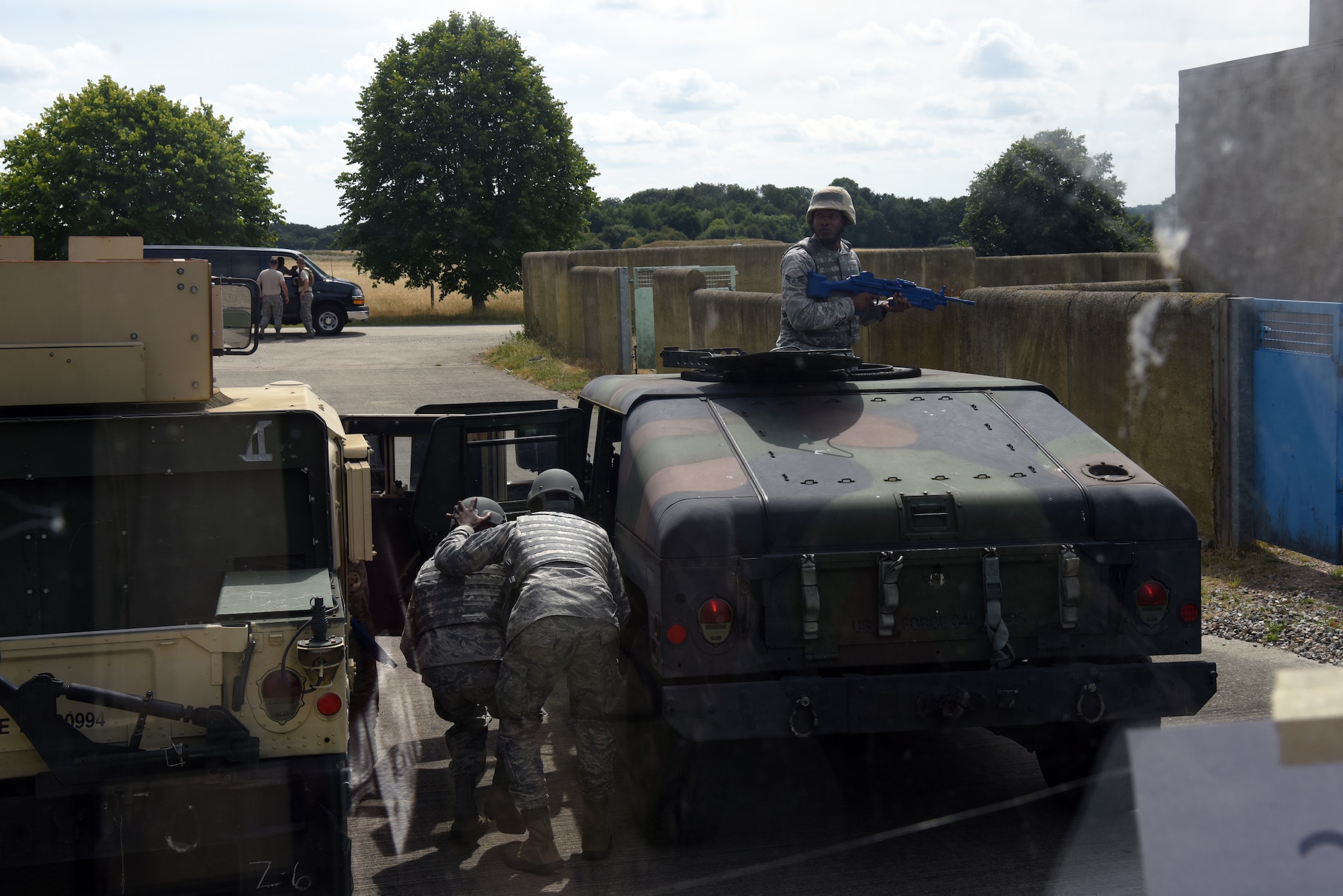Ground transportation specialists assigned to the 48th Logistics Readiness Squadron and 100th Logistics Readiness Squadron transport simulated wounded from a disabled Humvee after an improvised explosive device roadside bomb detonation at the Stanford Training Area, Suffolk, England, Aug. 4, 2018. Airmen from the ground transporation career field are required by their Air Force Instruction to conduct 100 hours of convoy training every two years. (U.S. Air Force photo/ Airman 1st Class John A. Crawford)