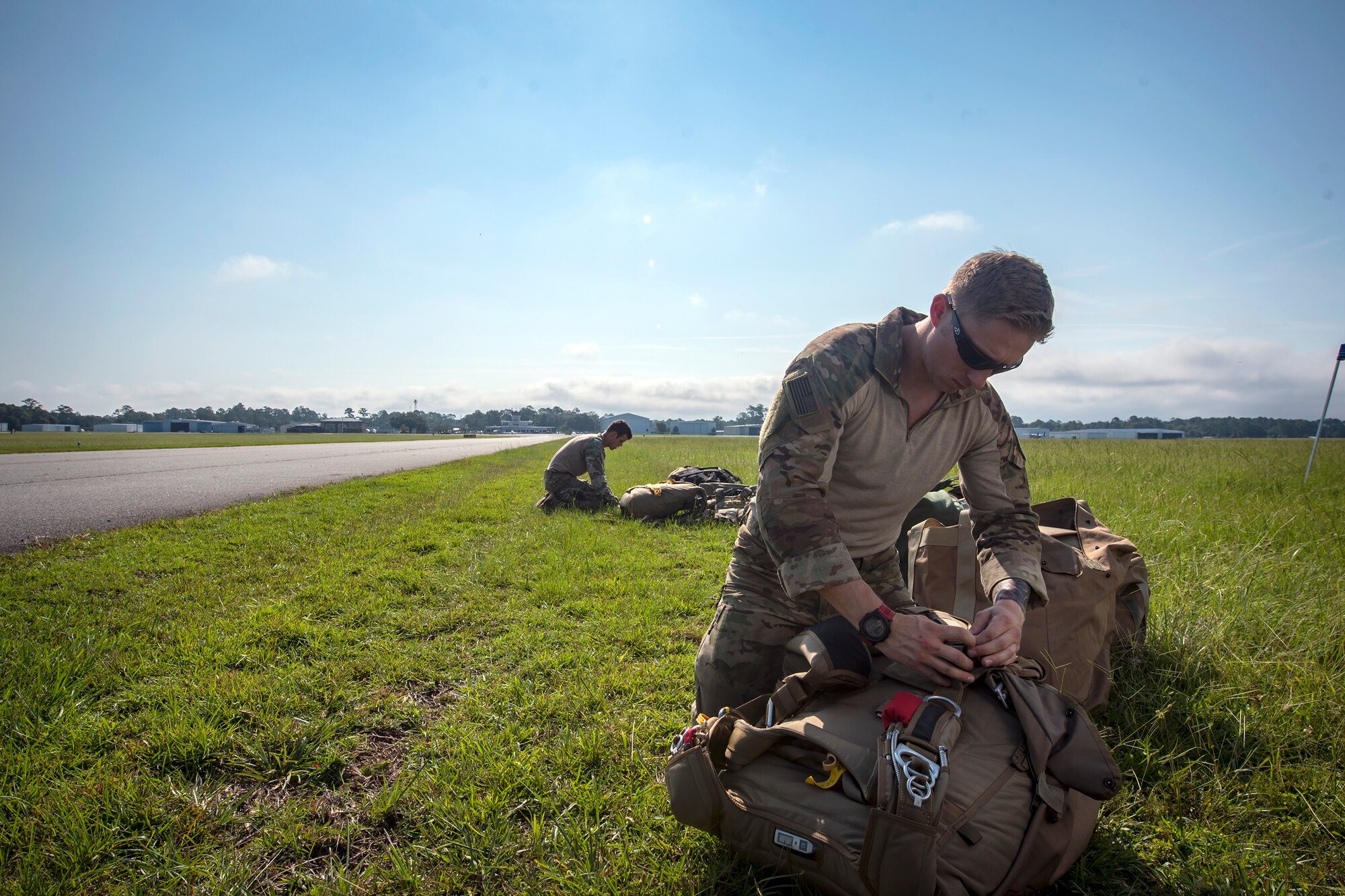 Pararescuemen (PJ) from the 38th Rescue Squadron (RQS), check their gear prior to a static-line jump, July 24, 2018, in Valdosta, Ga. PJs performed static-line jumps to maintain their jump proficiency qualifications. The mission of the 38th RQS is to employ combat ready rescue officers and pararescuemen to support units worldwide. (U.S. Air Force photo by Airman 1st Class Eugene Oliver)