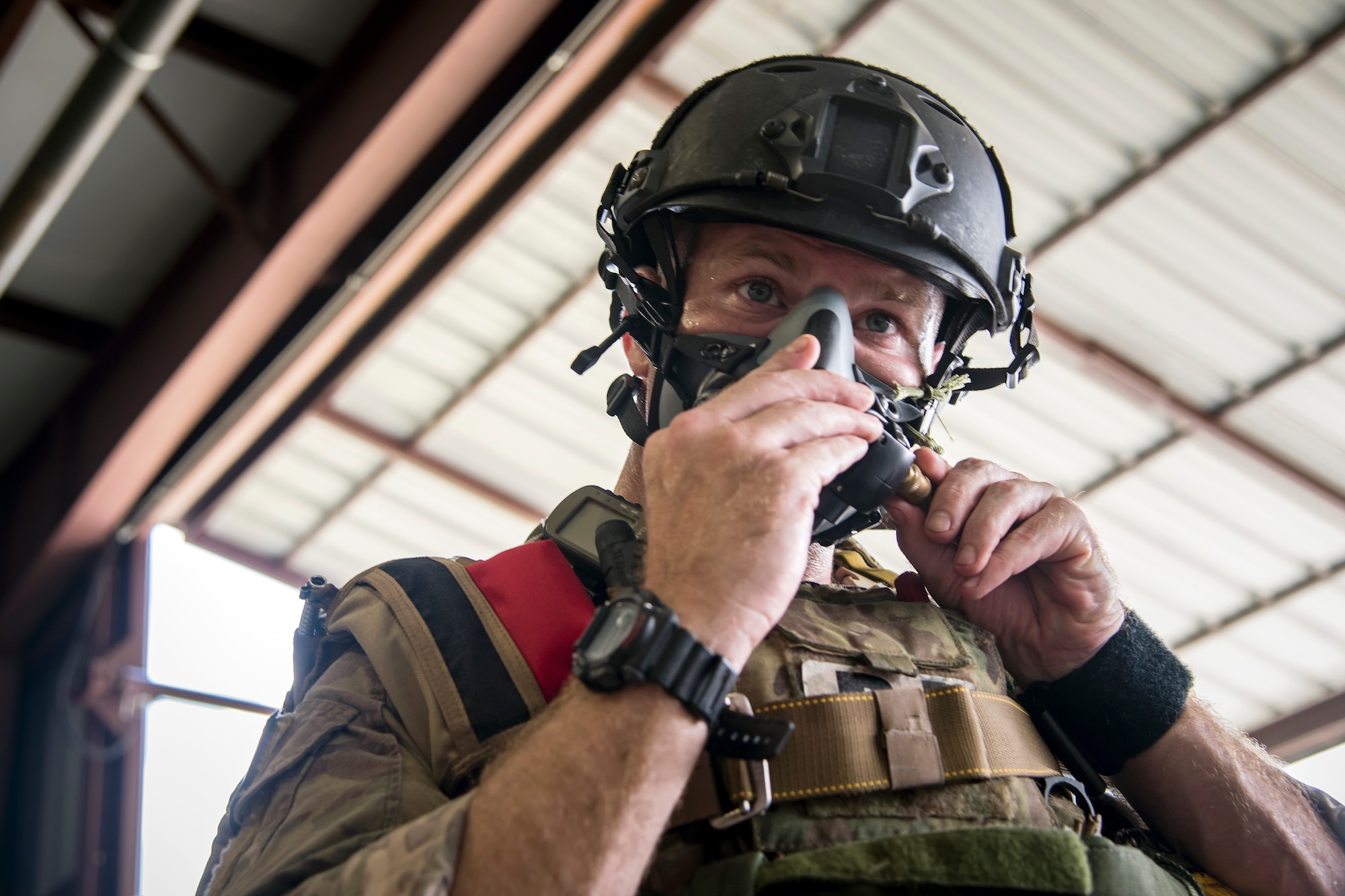 A Pararescueman (PJ) from the 38th Rescue Squadron (RQS), adjusts his oxygen mask prior to a static-line jump, July 24, 2018, at Valdosta, Ga. PJs performed static-line jumps to maintain their jump proficiency qualifications. The mission of the 38th RQS is to employ combat ready rescue officers and pararescuemen to support units worldwide. (U.S. Air Force photo by Airman 1st Class Eugene Oliver)