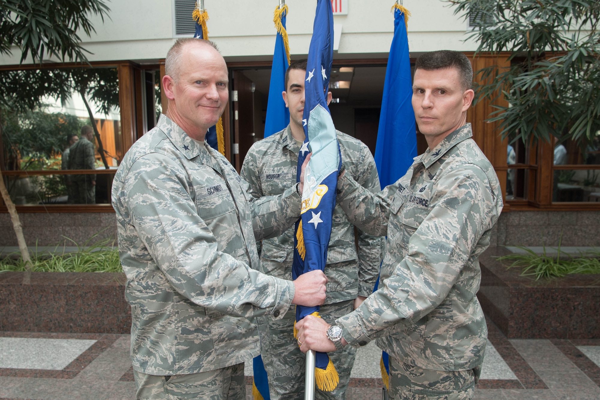 Brig. Gen. Michael Schmidt, left, Command, Control, Communications, Intelligence and Networks program executive officer, passes a guidon symbolizing Col. Jonathan Sorbet's assumption of leadership as the senior material leader for the Family of Advanced Beyond Line-of-Sight Terminals division within C3I&N August 8, at the MITRE Corp. in Bedford, Mass. (U.S. Air Force photo by Jerry Saslav)