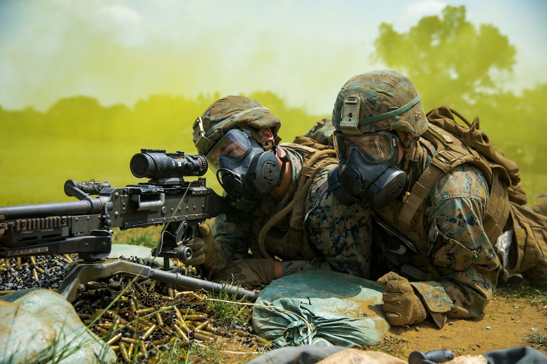 Marines put on gas masks and prepare for target practice during Exercise Platinum Lion 18.
