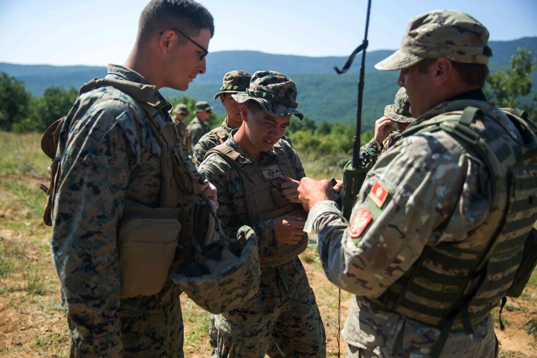Marines speak with Montenegrin soldiers during Exercise Platinum Lion 18.