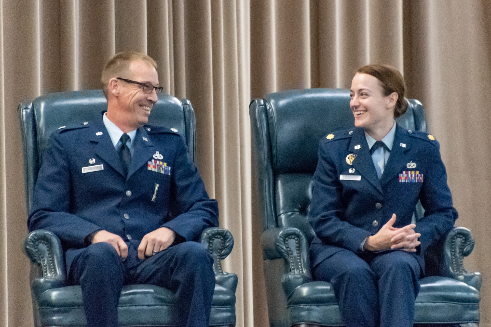 U.S. Air Force Lt. Col. Warren Crabtree, outgoing 707th Maintenance Squadron commander, shares a light moment with the incoming 707th MXS commander Maj. Jessica Oberlander during the unit’s change of command ceremony at Barksdale Air Force Base, Louisiana, August 5, 2018.   The 707th MXS is a nuclear certified unit and has adopted the nickname ‘Nuclear Rats’.  (U.S. Air Force photo by Technical Sgt. Cody Burt/Released)